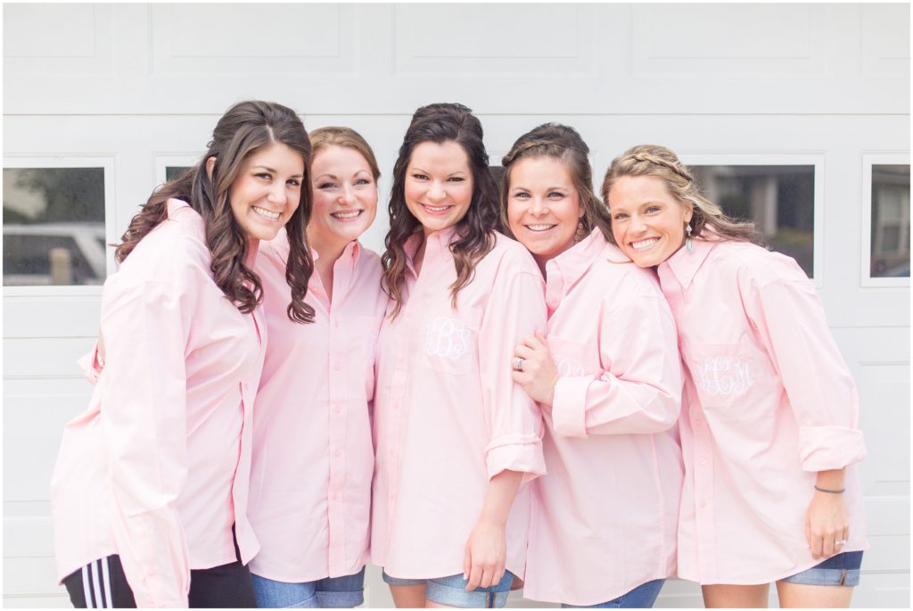bridal party in pink button up shirts while they get ready for SC wedding