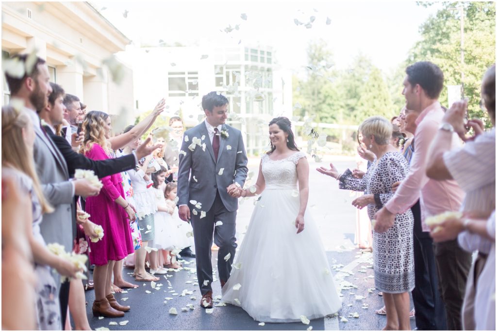 guests celebrate newlyweds outside of wedding ceremony