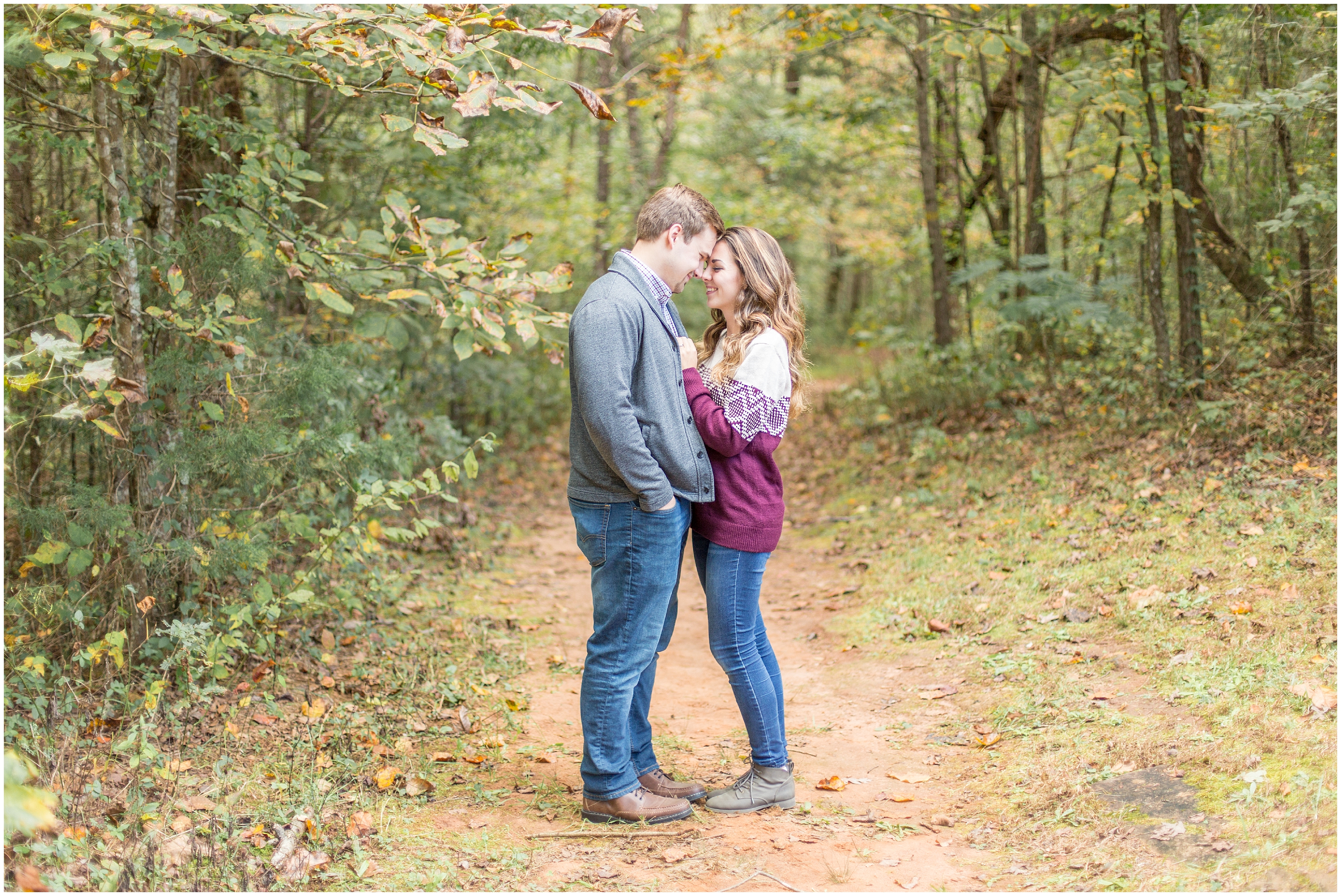 couple kiss in the woods near Campbell’s Covered Bridge in SC
