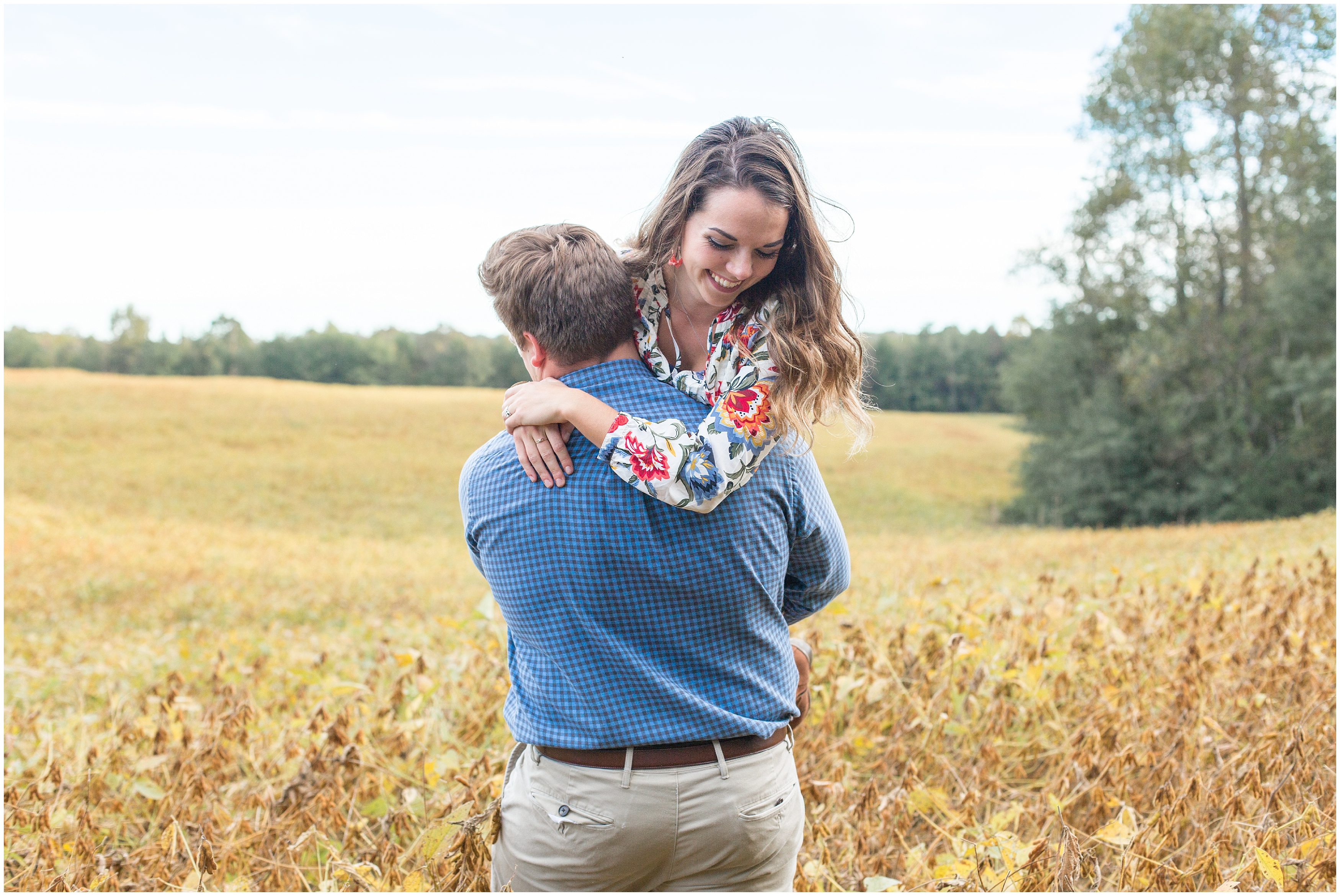 man lifts up fiance during  covered Bridge engagement session in SC 
