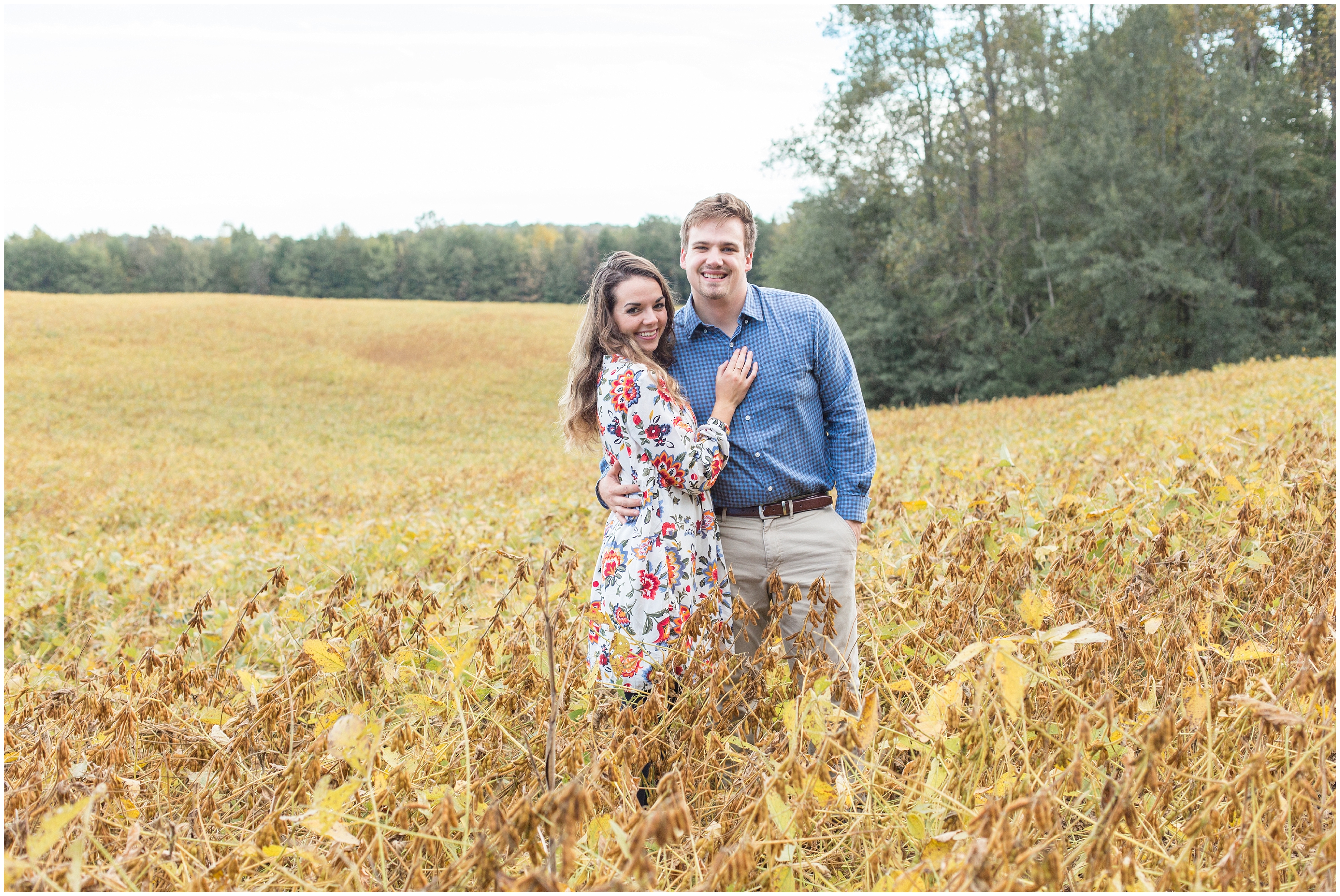 engaged couple in tall grass during  covered Bridge engagement session