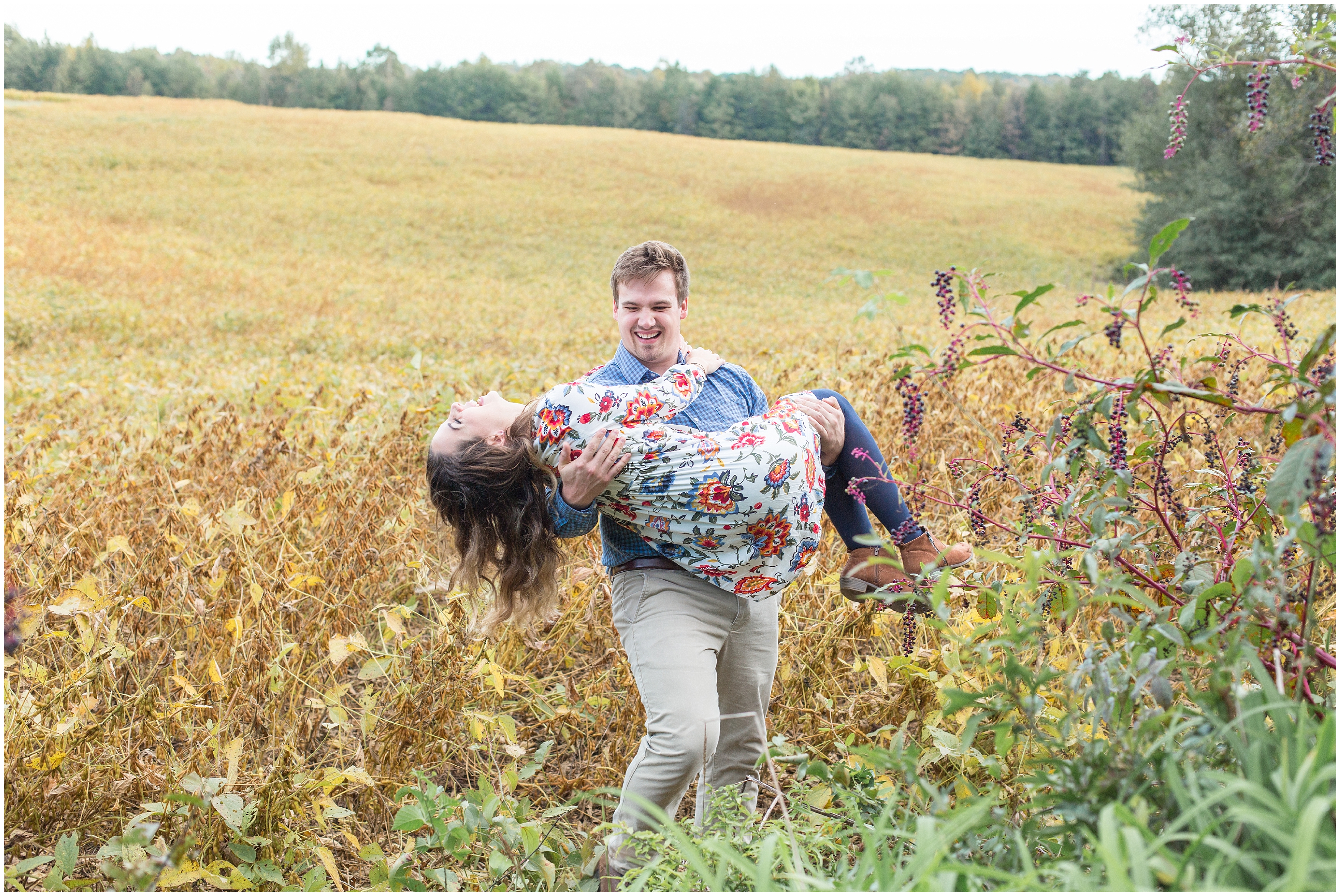 man carries fiance through tall grass in greenville SC