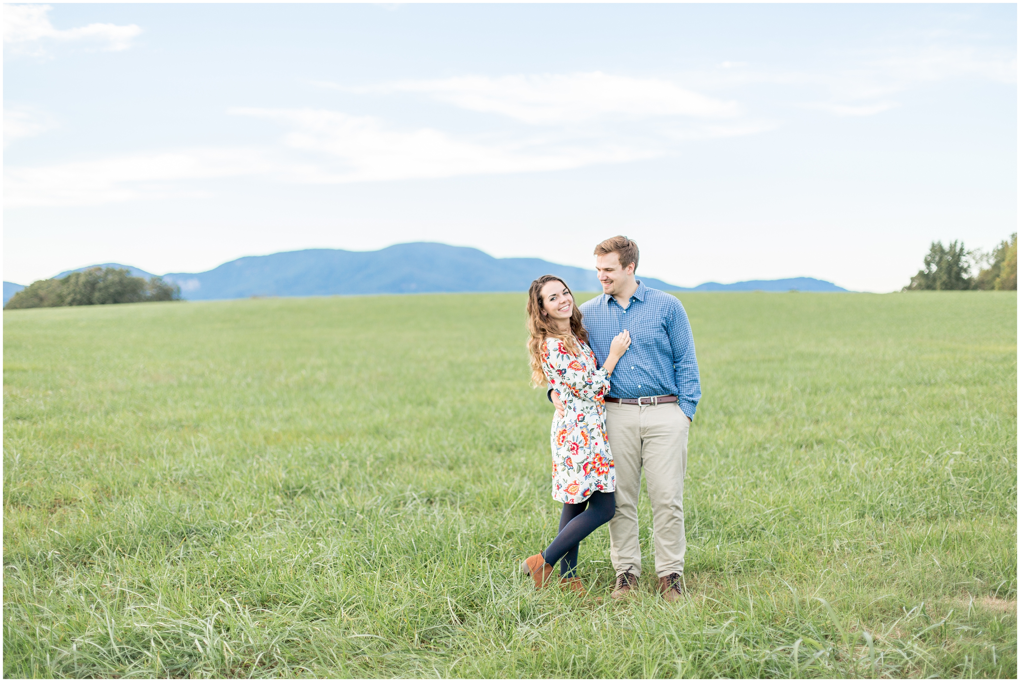 couple in green field with blue skies 