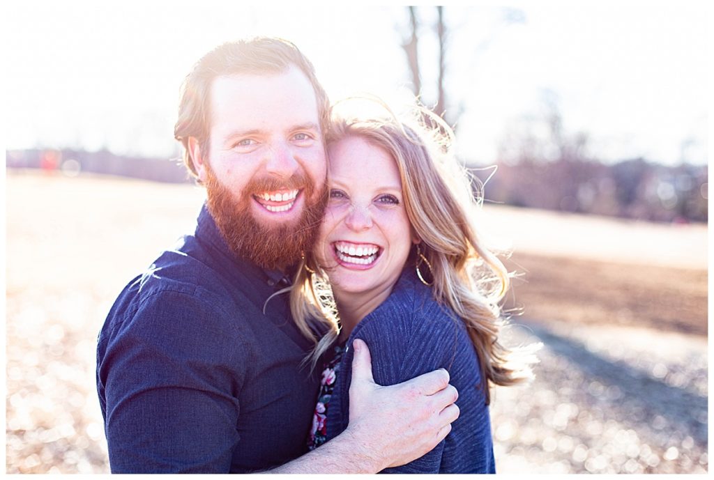 couple smile and laugh for engagement photos 
