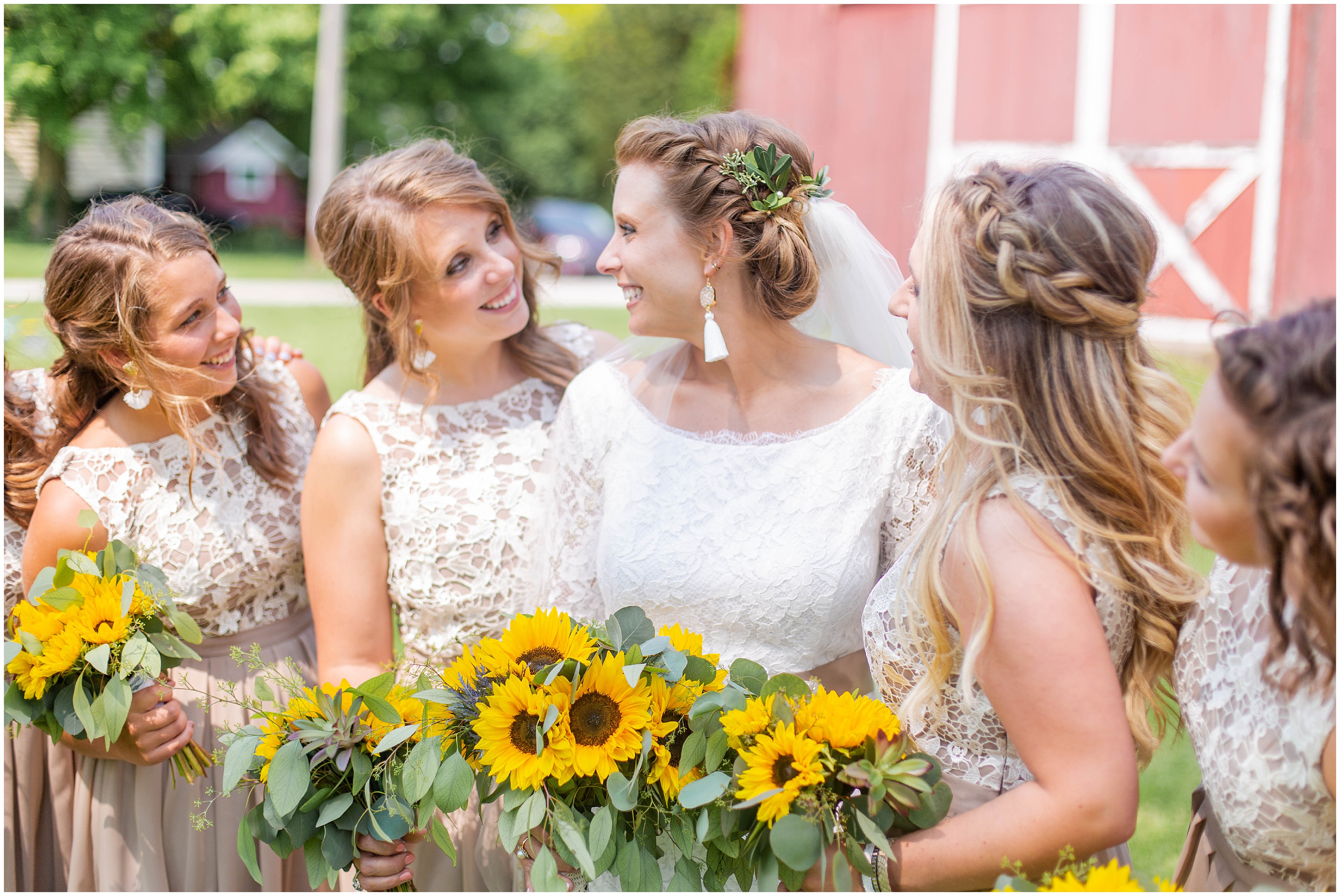 bride with her bridesmaids holding sunflower bouquets 