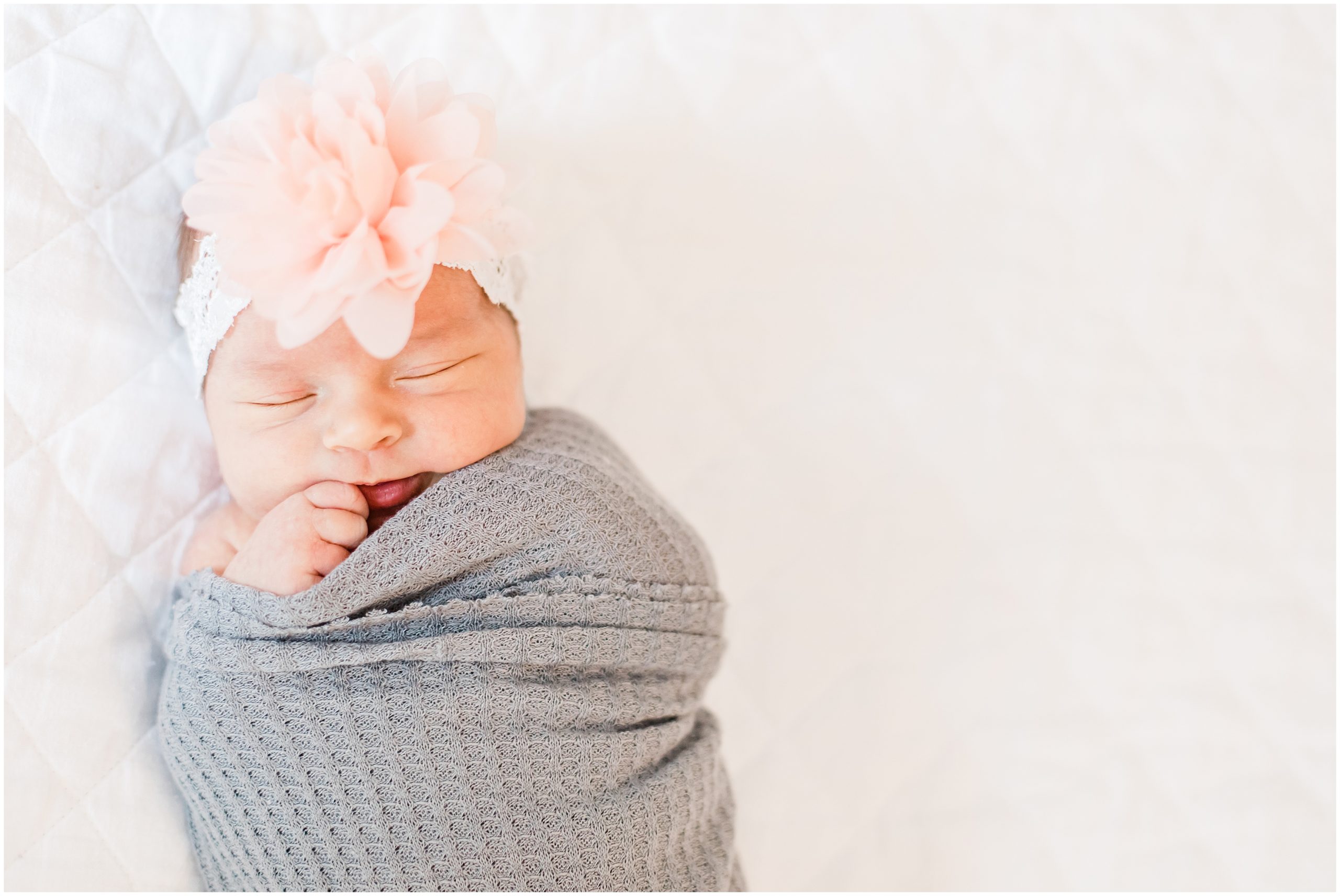 baby in grey wrap sleeps during Lifestyle Newborn Session in Charlotte