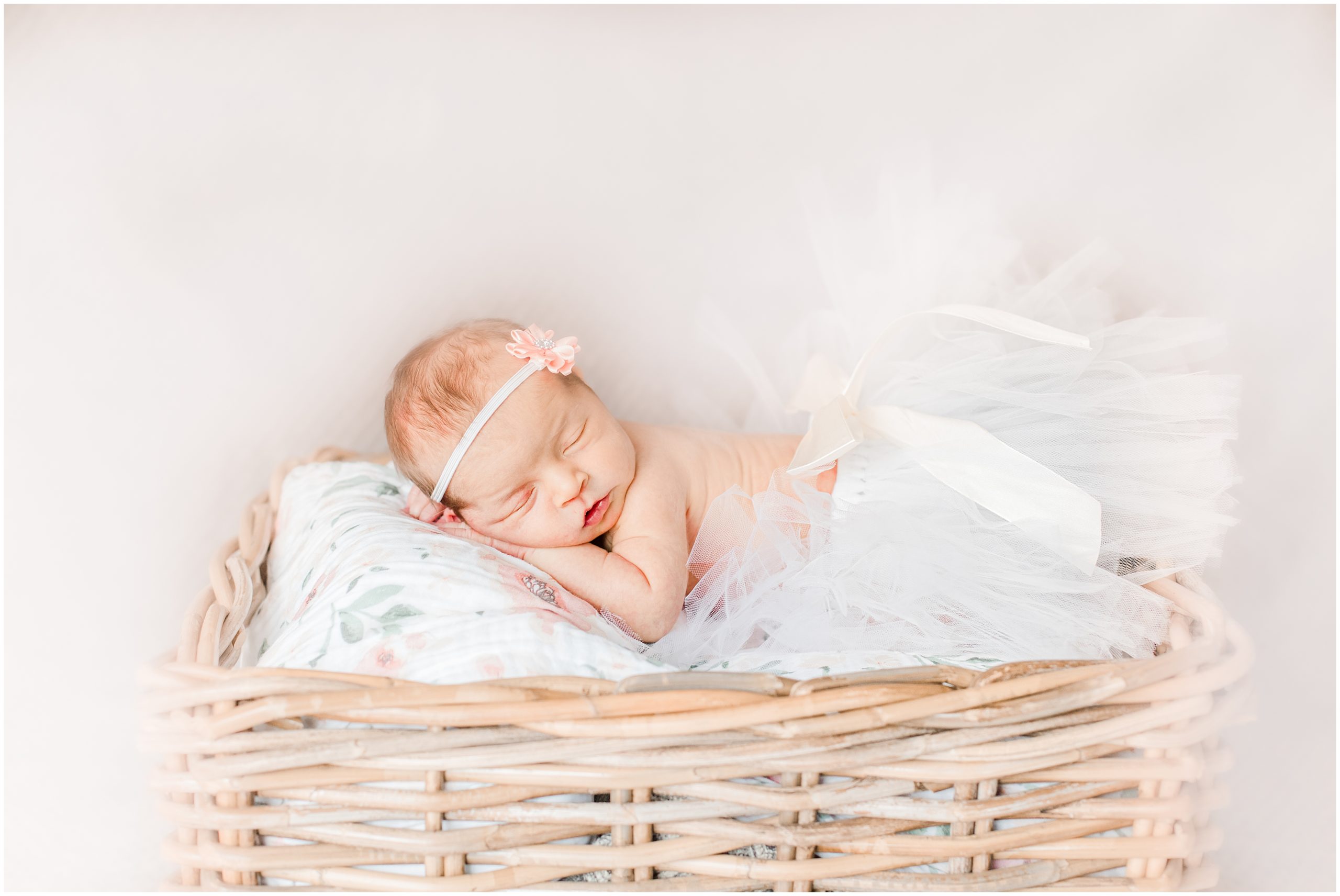 baby lays in basket during newborn photos