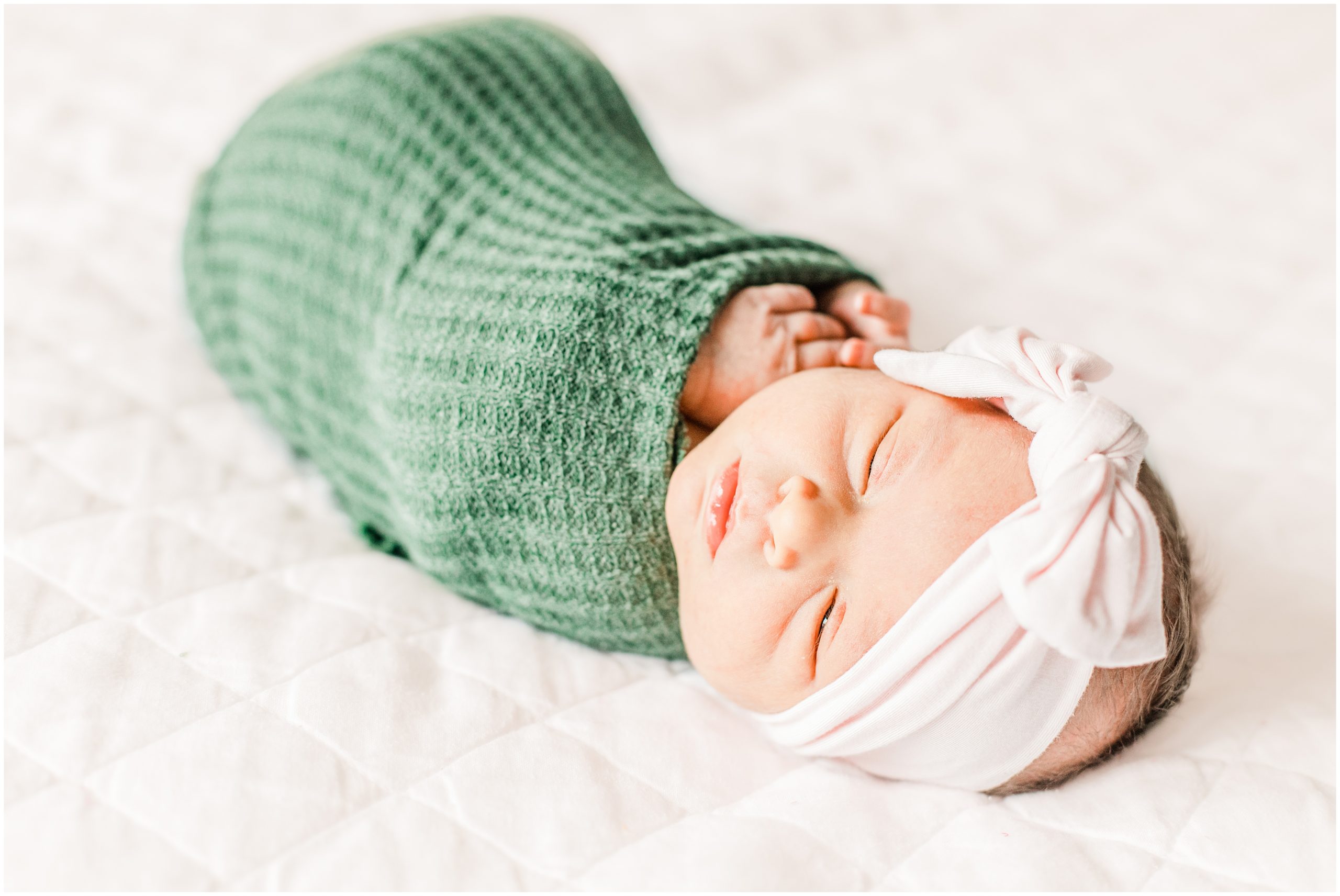 baby in green wrap during Lifestyle Newborn Session in Charlotte