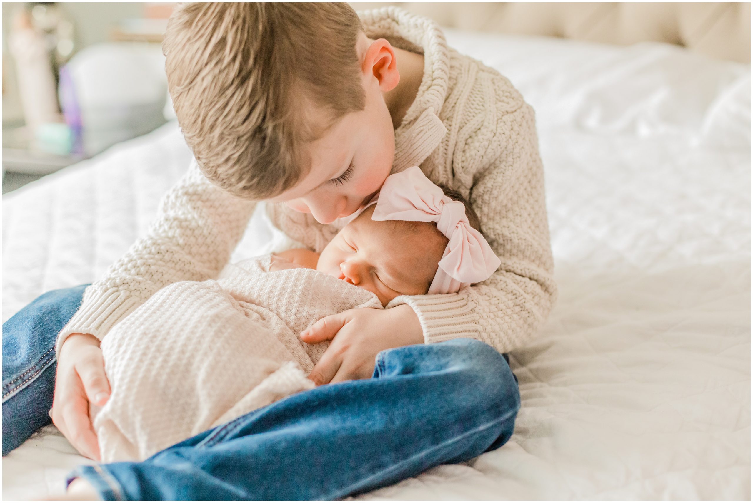 big brother kisses little sister during NC newborn photos