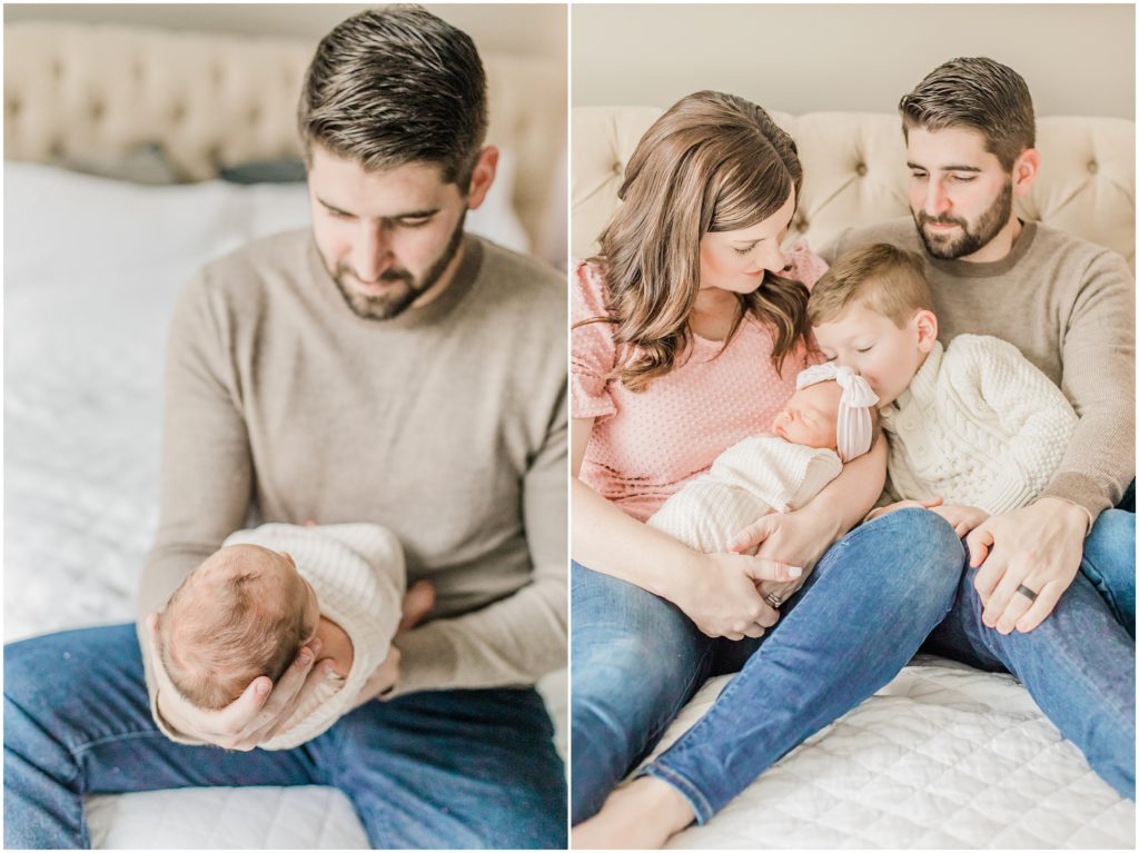 parents look at baby girl during newborn session at home