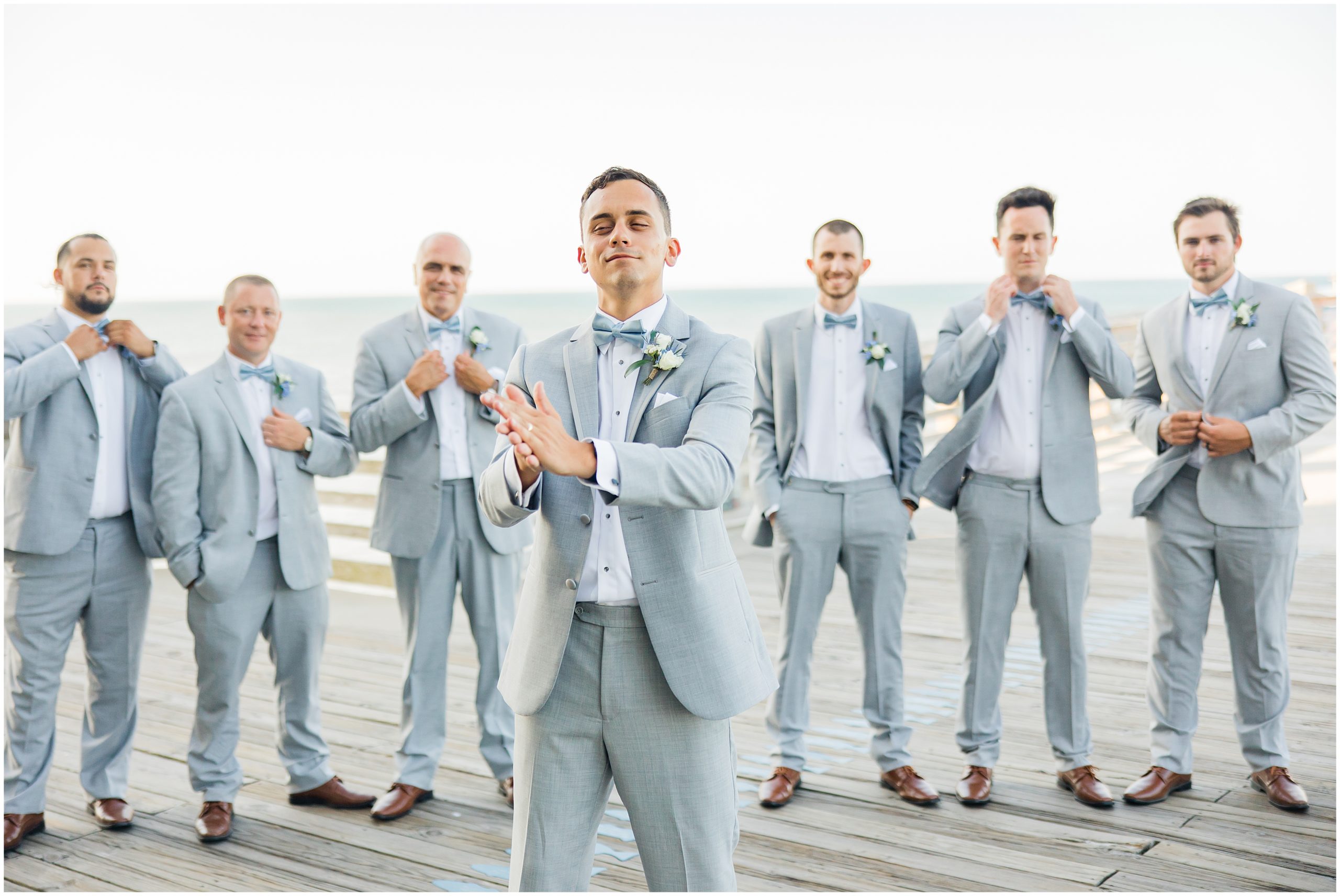 groom and groomsmen pose on Jennette's Pier in Nags Head NC