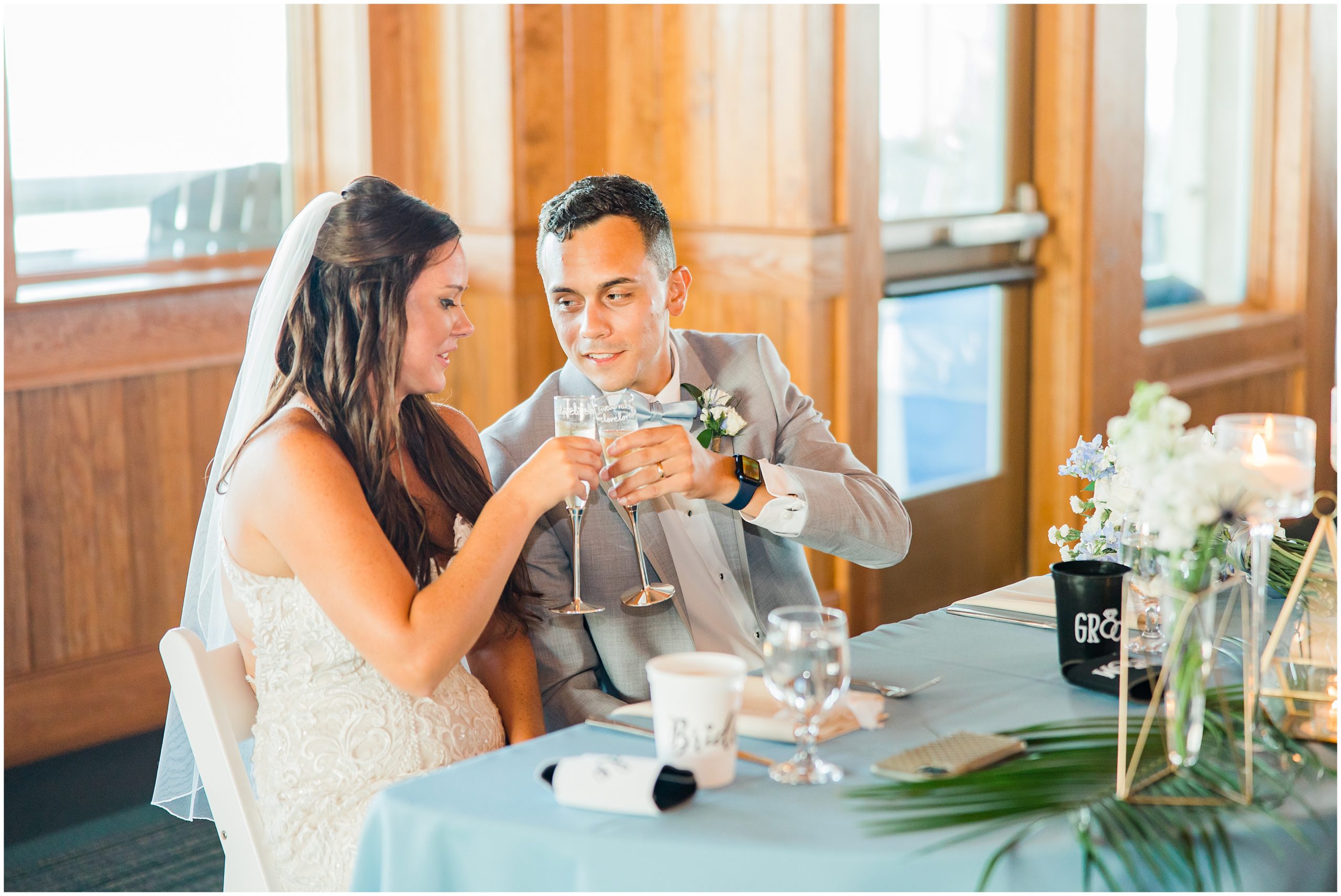 bride and groom toast with champagne at Jennette's Pier