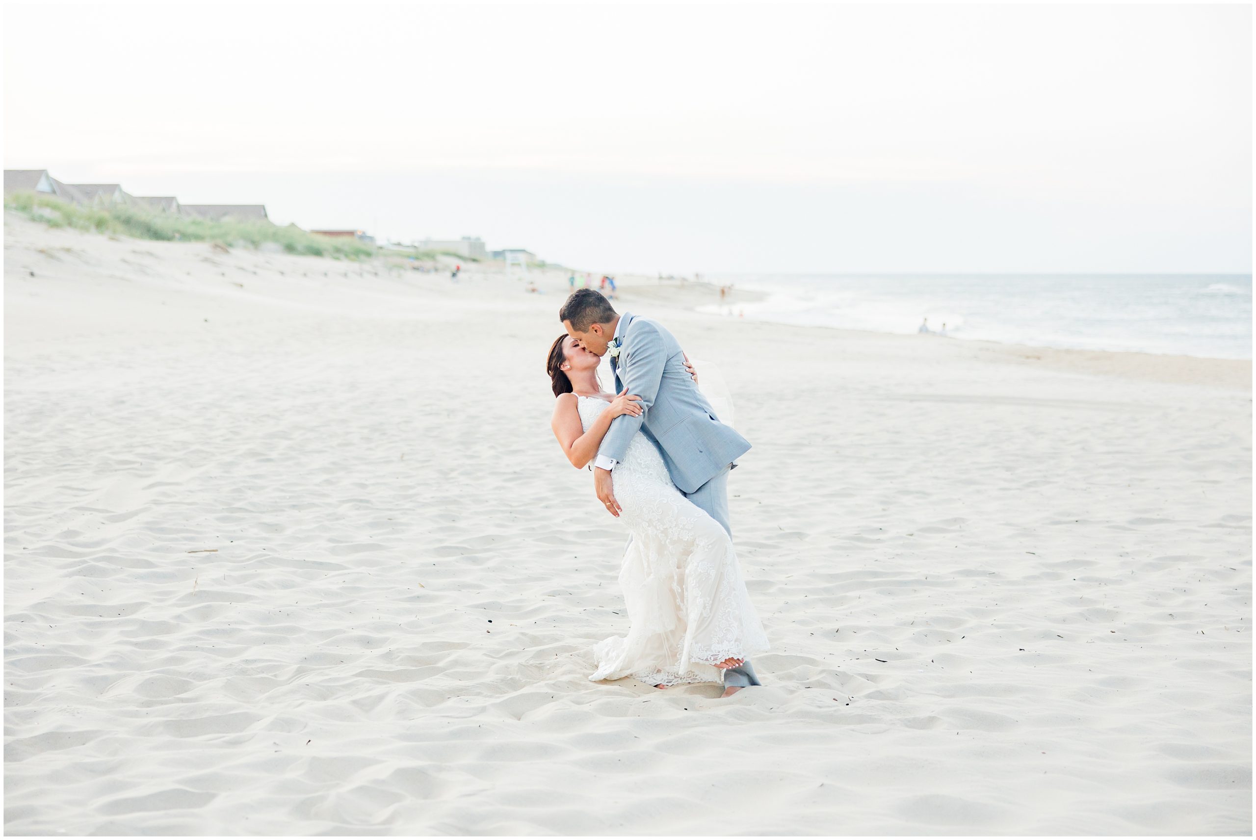 bride and groom kiss on beach in the Outer Banks