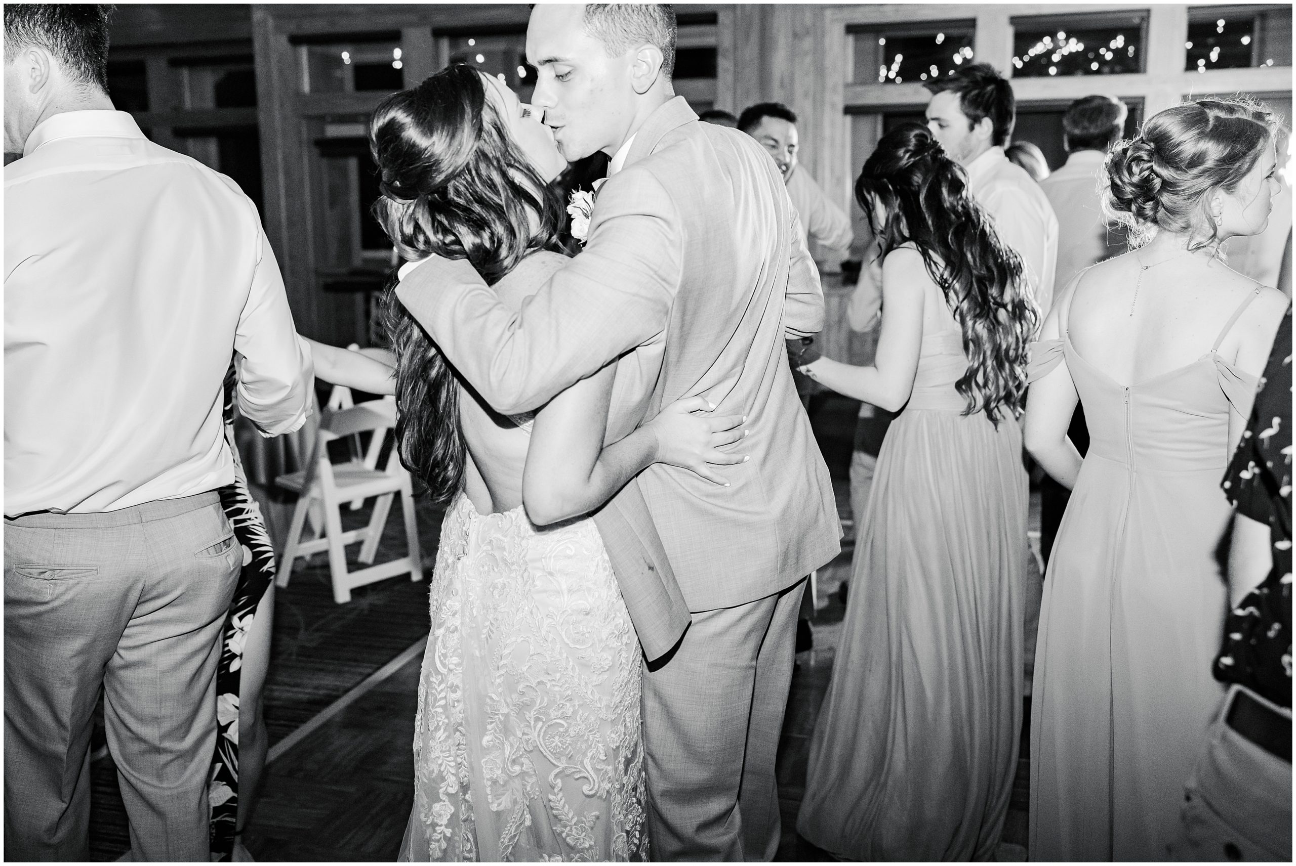 bride and groom kiss during NC wedding reception