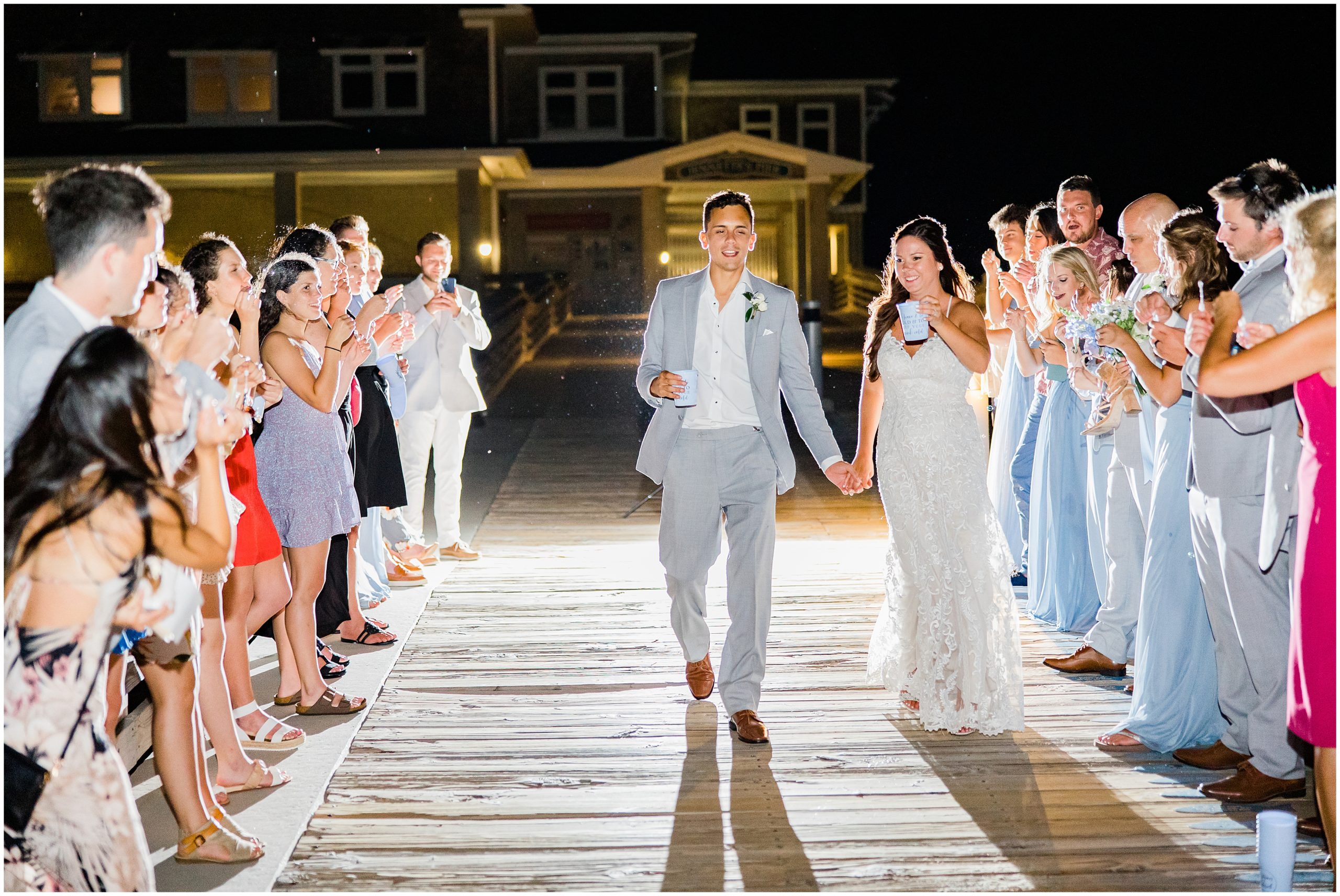 newlyweds walk down pier after Jennette's Pier Wedding