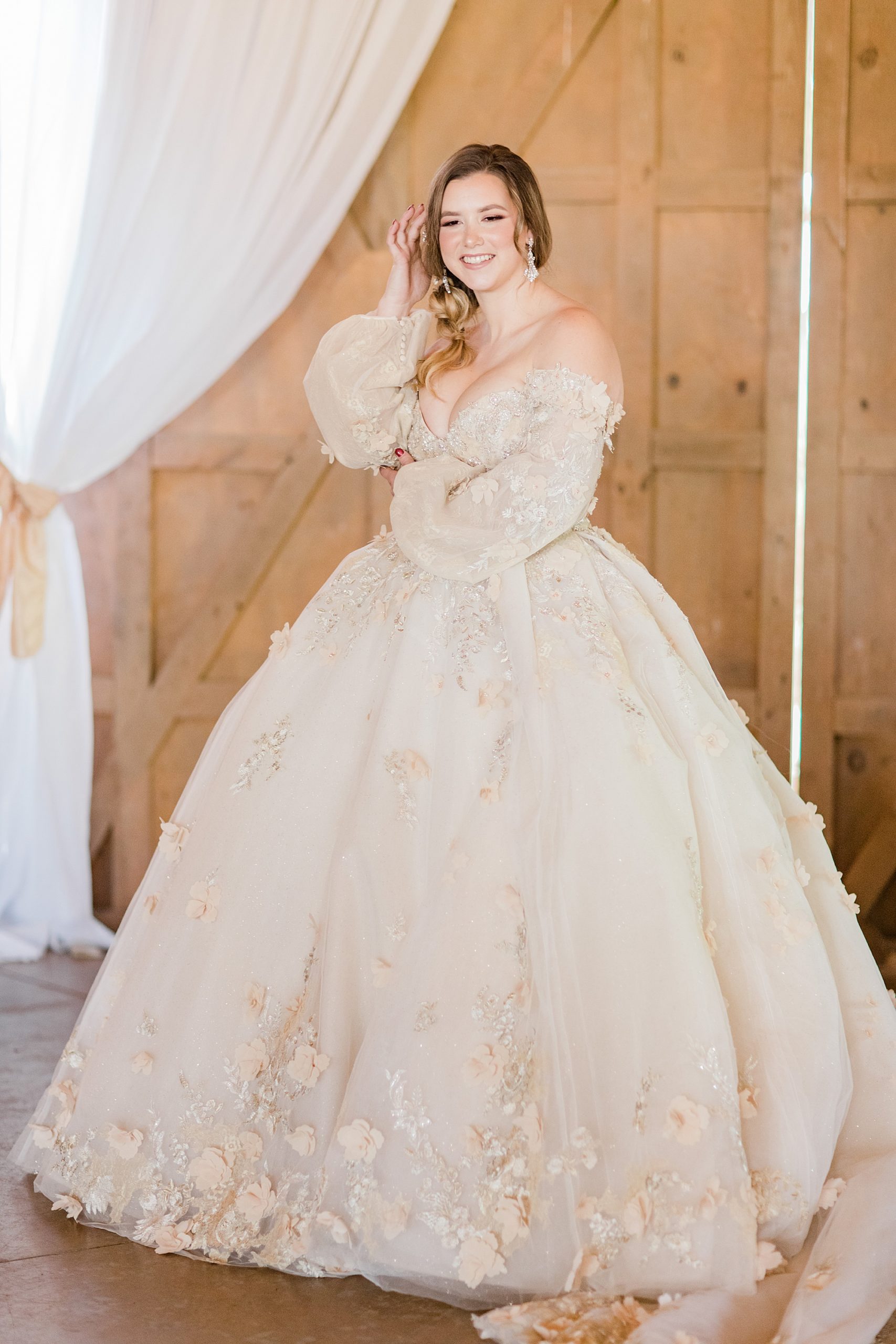 bride in ballgown stands before wooden door at Carolina Country Weddings