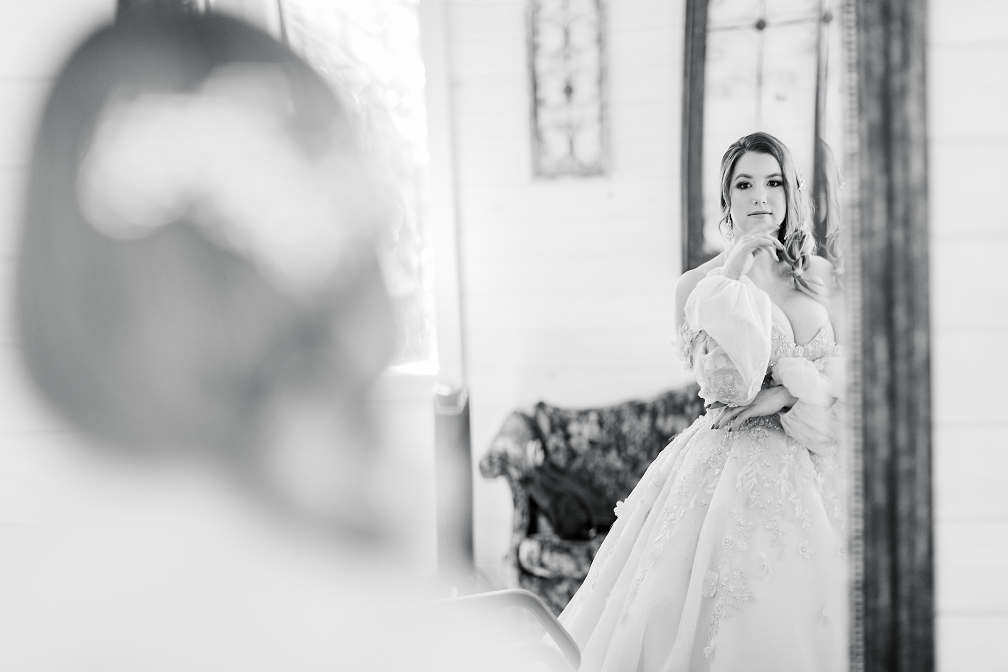 bride looks at reflection in mirror at Carolina Country Weddings