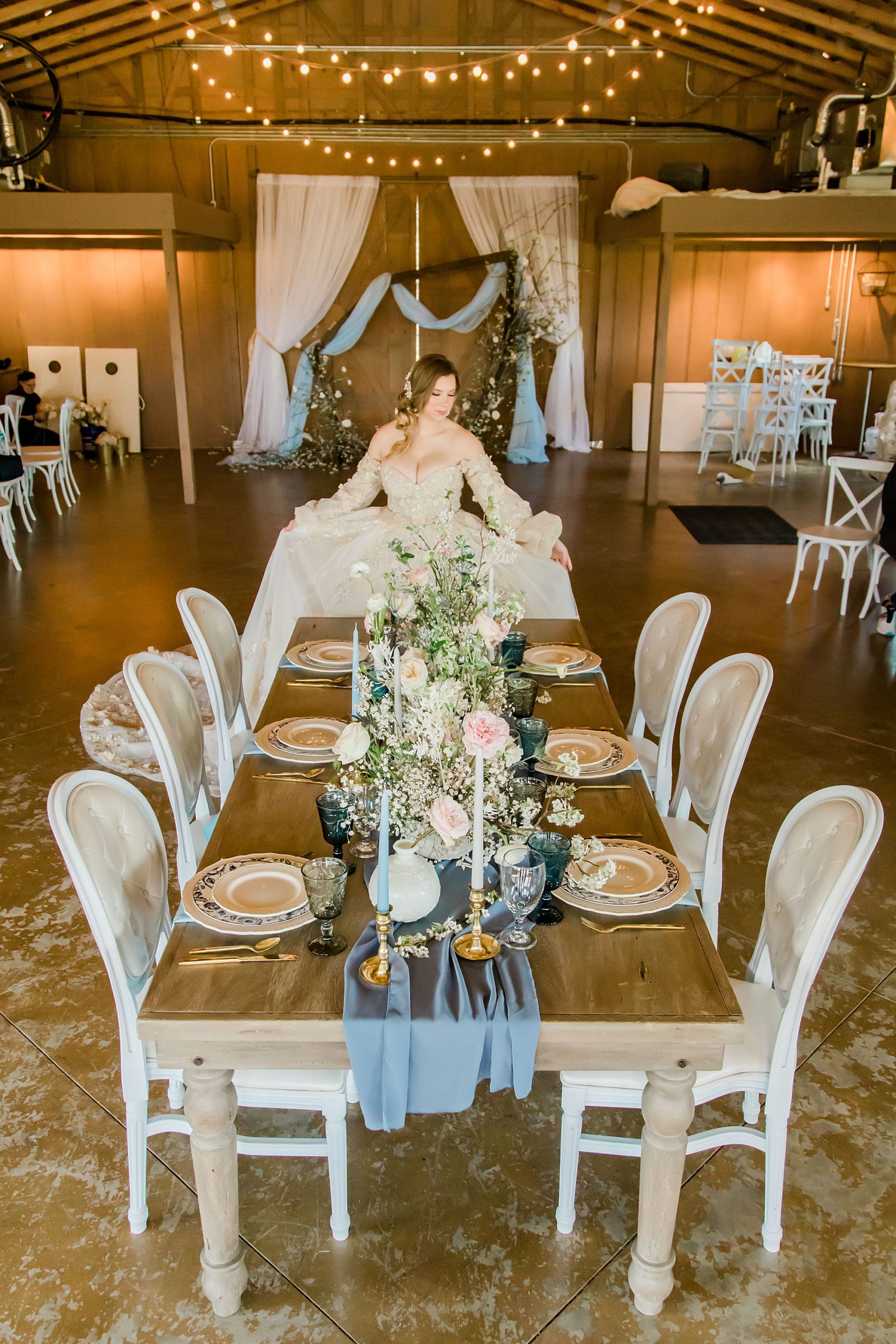 bride poses at head of table during Carolina Country Weddings reception