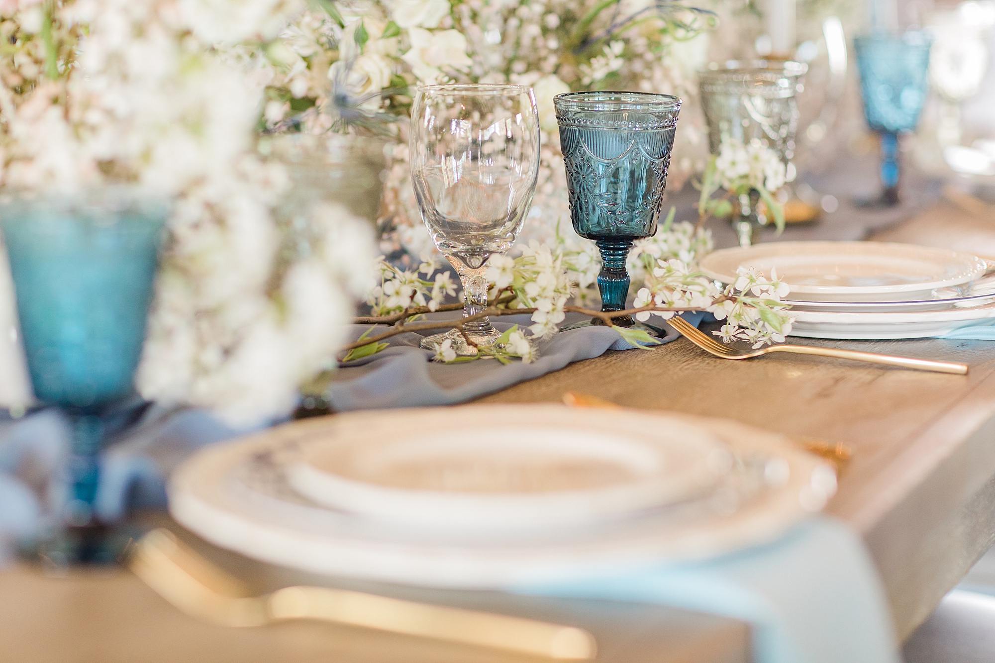 place settings with vintage blue glasses