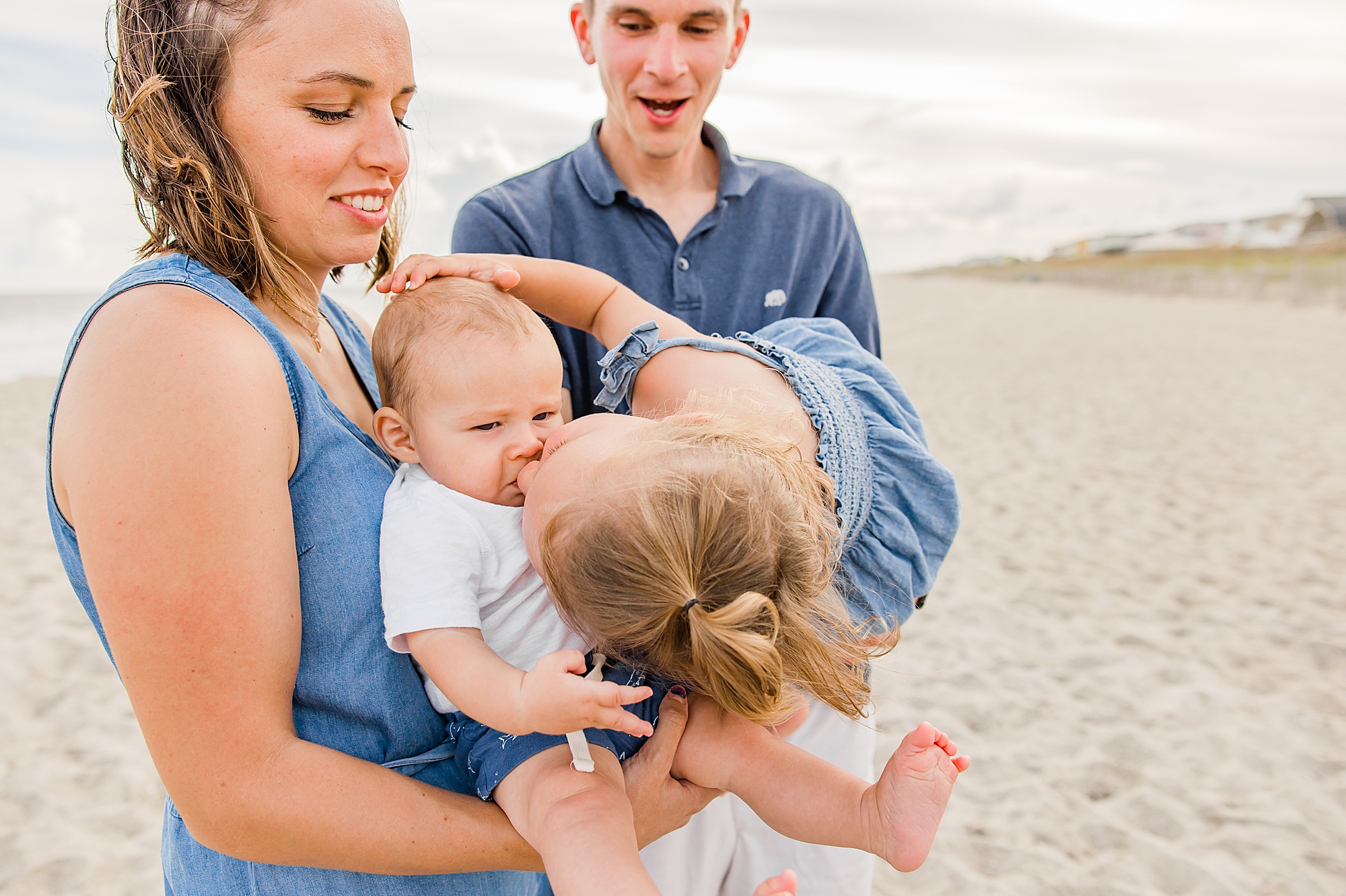 toddler kisses baby sibling during Holden Beach family photos