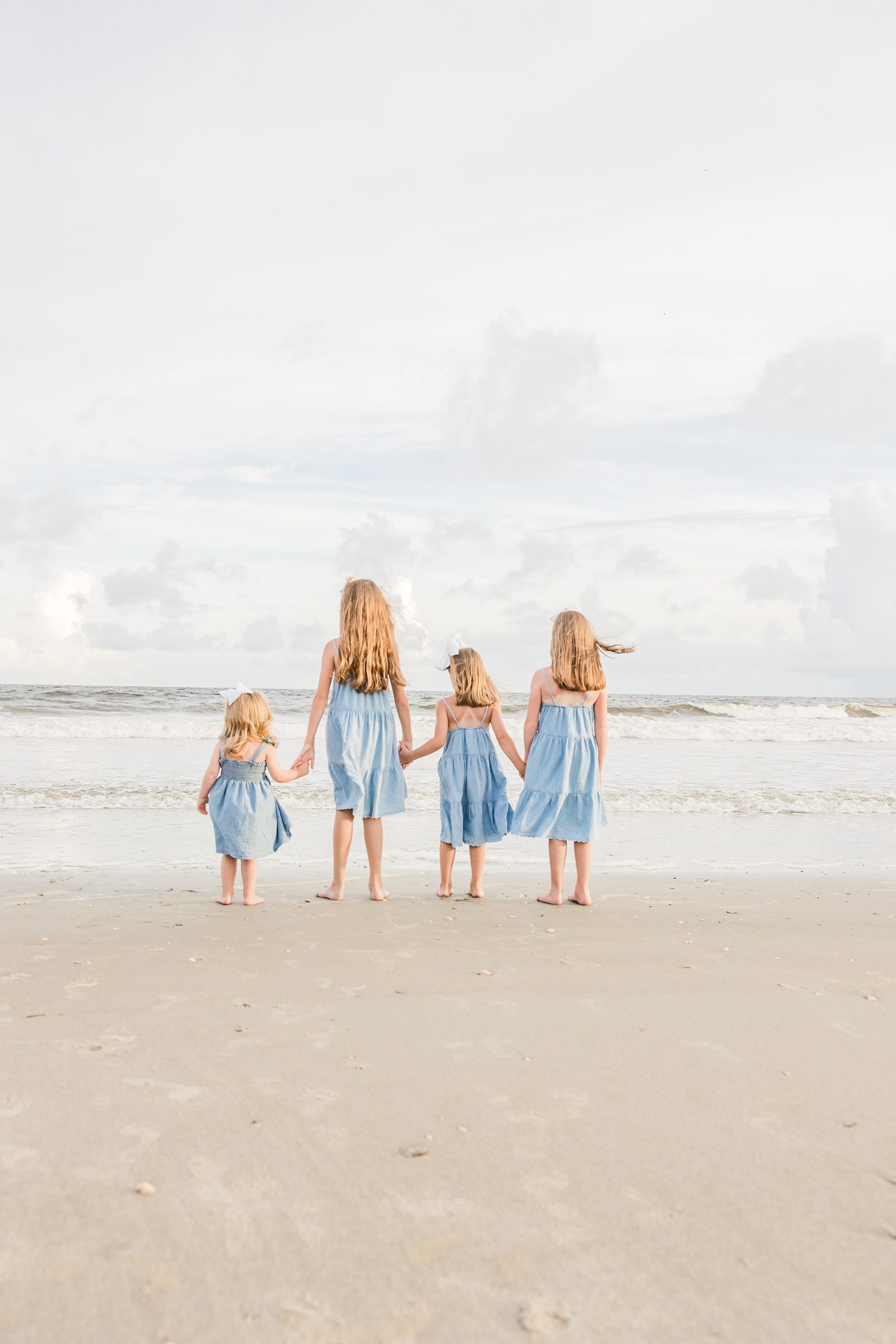 four girls walk on sand during Holden Beach family photos
