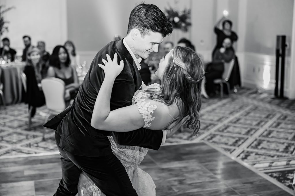 groom dips bride during first dance at Asheville NC wedding reception