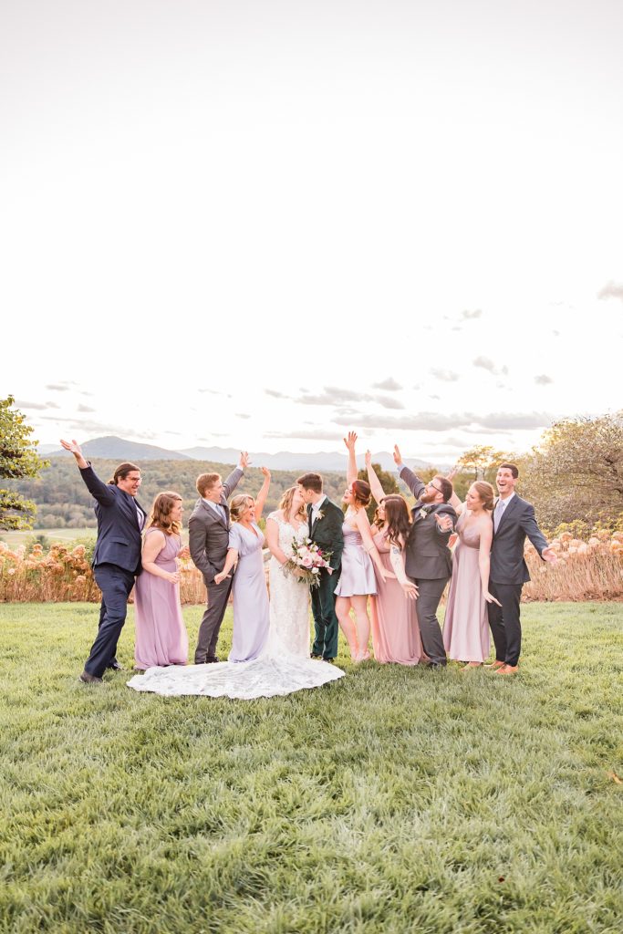 bride and groom cheer with wedding party after Asheville NC outdoor wedding ceremony