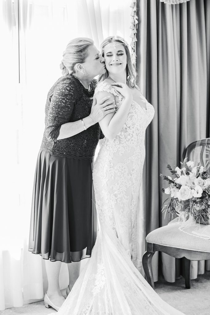 mother of the bride kisses bride's cheek during Biltmore Estate wedding prep