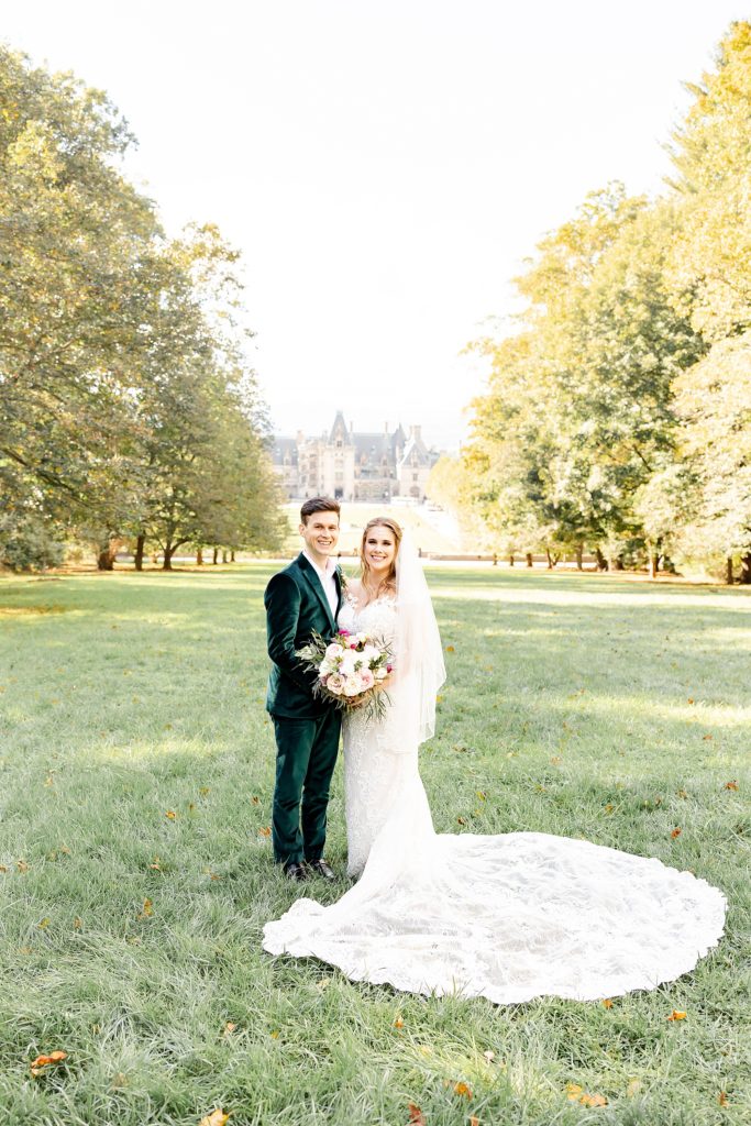 newlyweds stand on lawn at the Biltmore Estate