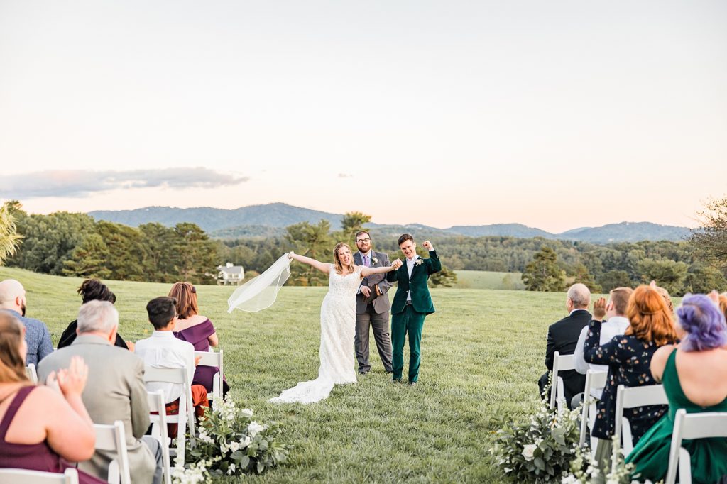 newlyweds cheer after Asheville NC outdoor wedding ceremony