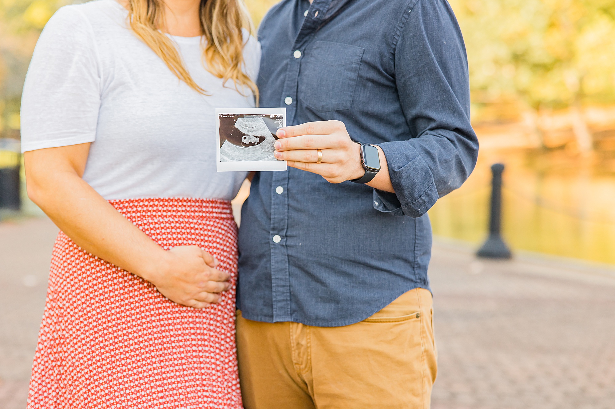 couple holds sonogram during Cleveland Park family portraits