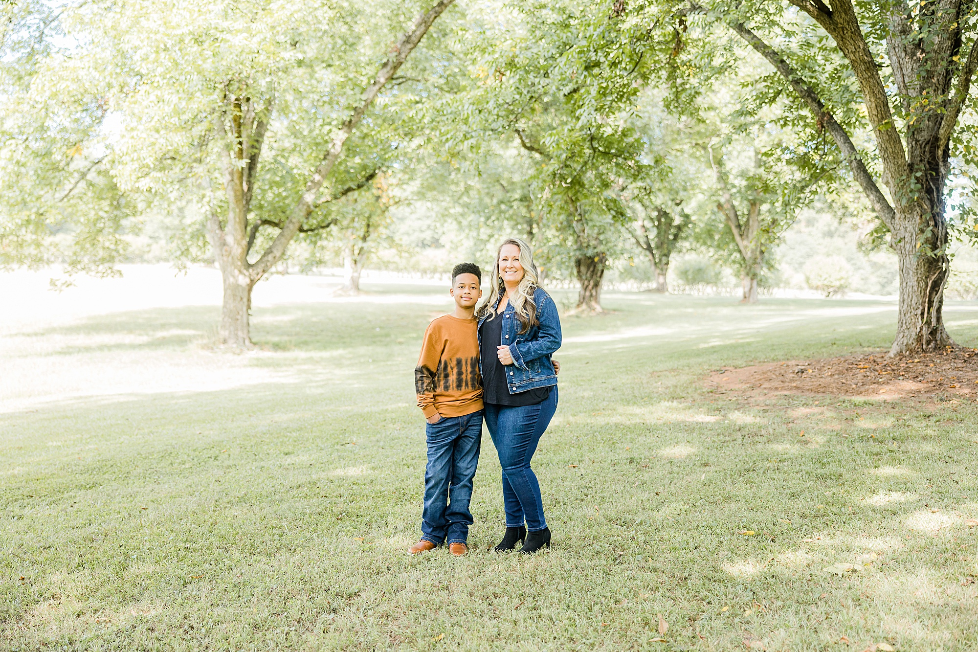 mother and son pose in Charlotte park during fall family portraits
