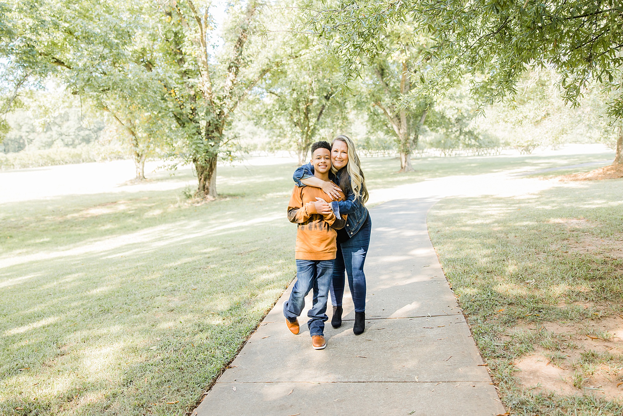 mom hugs son during family photos in the fall