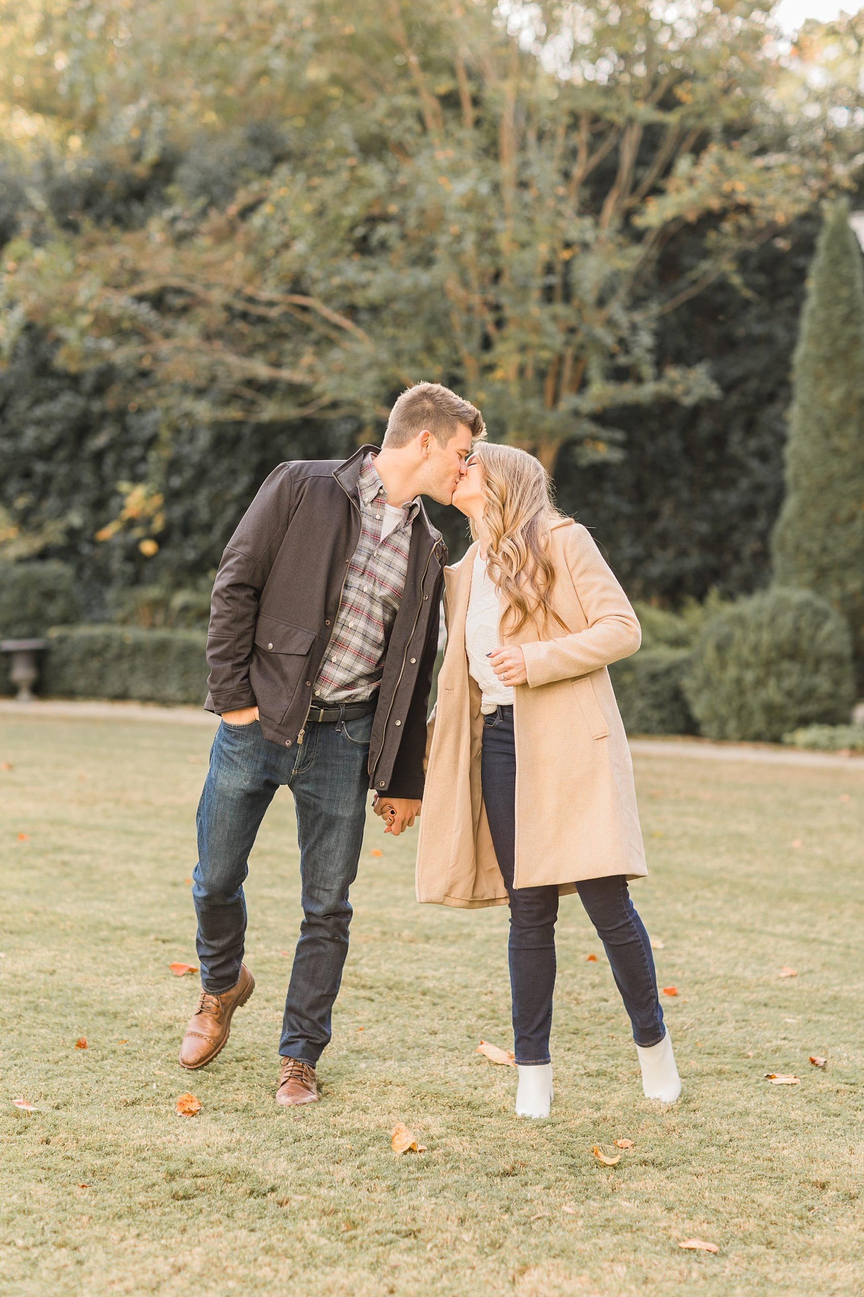 couple kisses during proposal at Duke Mansion