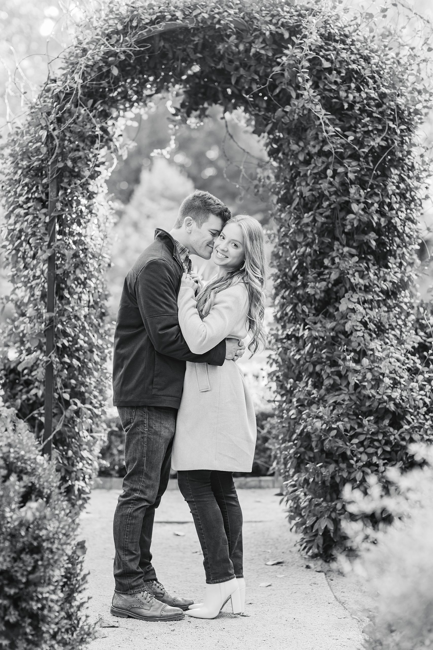 groom nuzzles fiancee after Duke Mansion proposal in gardens 