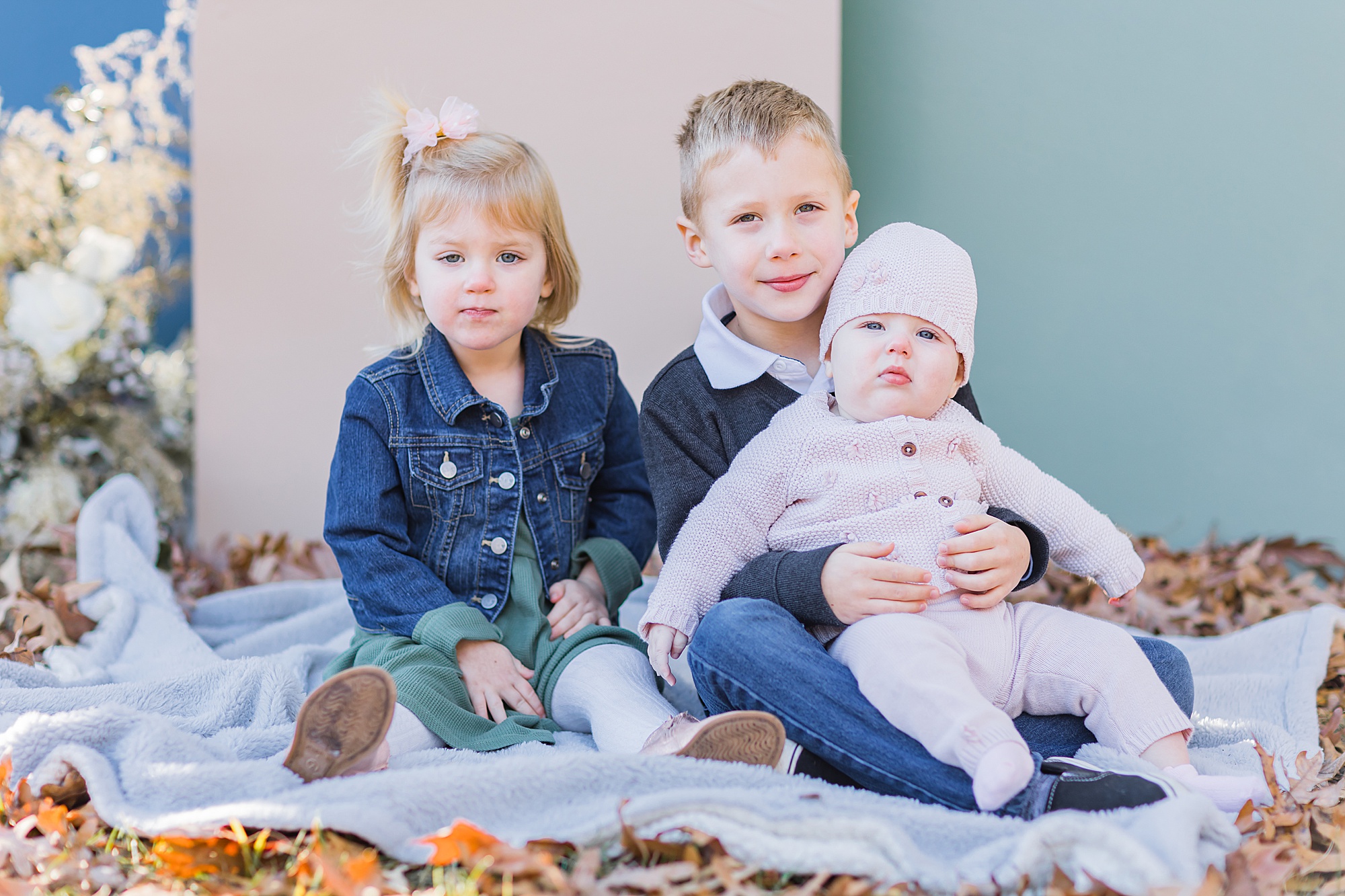 three siblings sit on blanket during  Lancaster SC family session