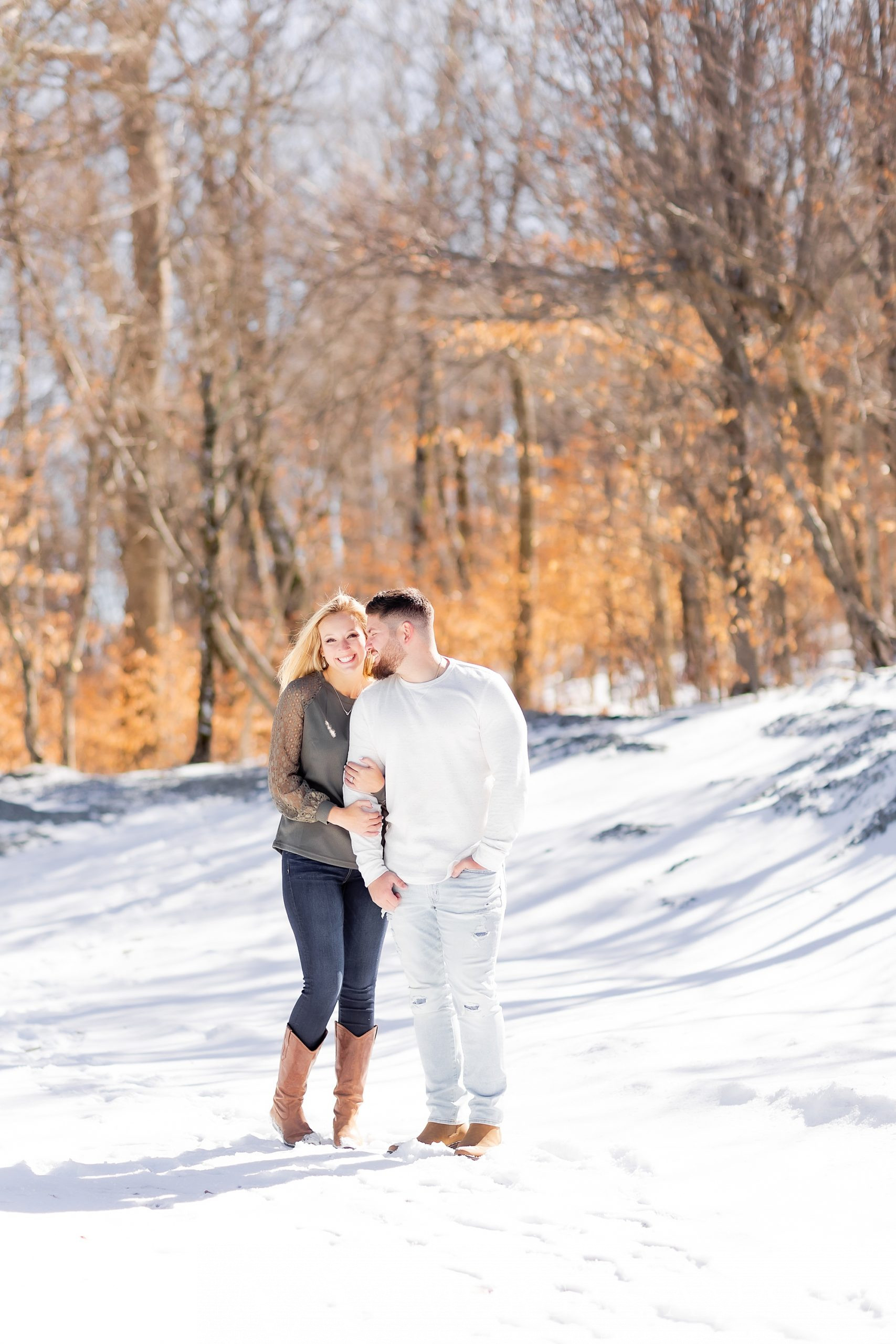 groom nuzzles bride's cheek during winter Beech Mountain engagement session