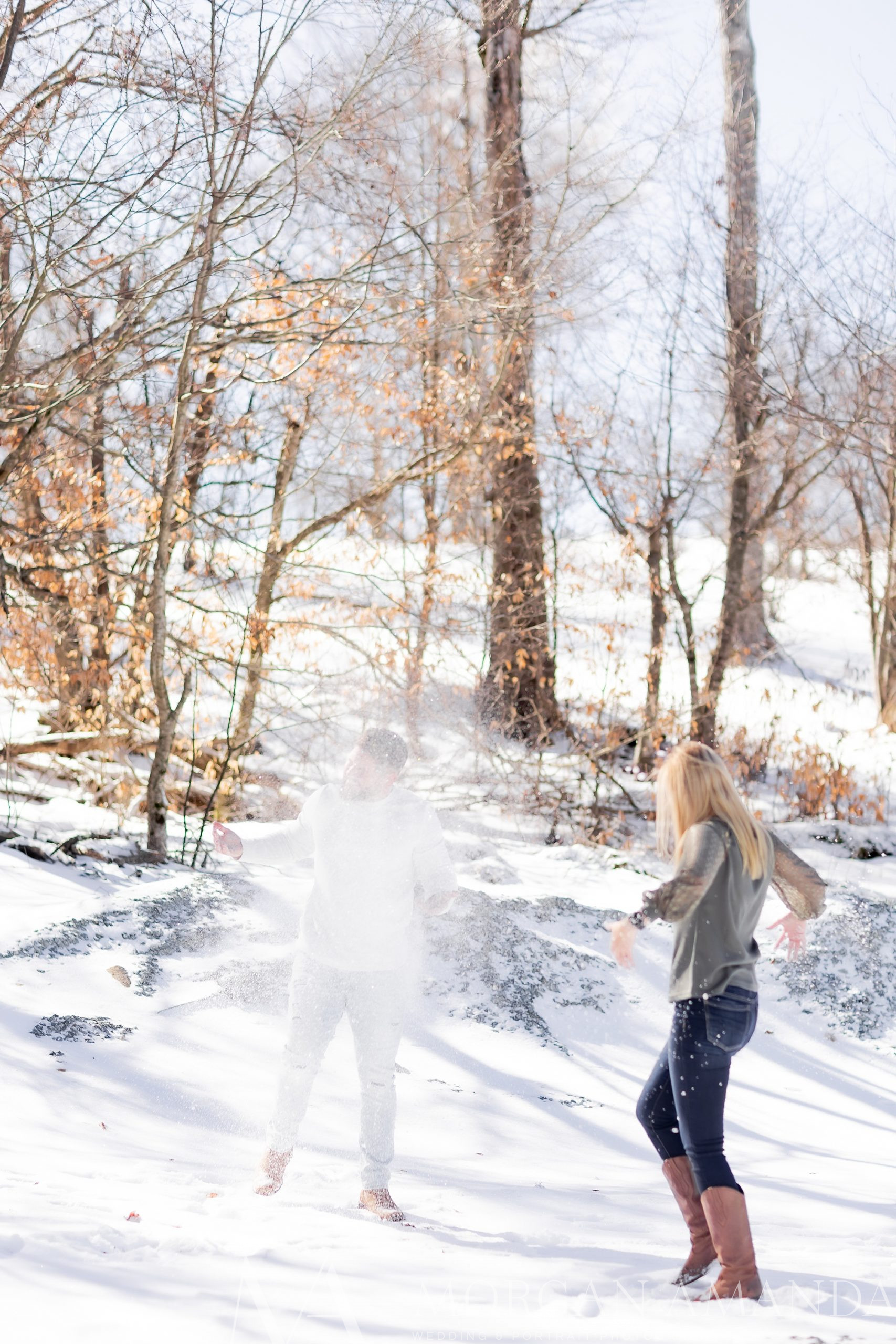 bride throws snow at groom during Beech Mountain engagement session