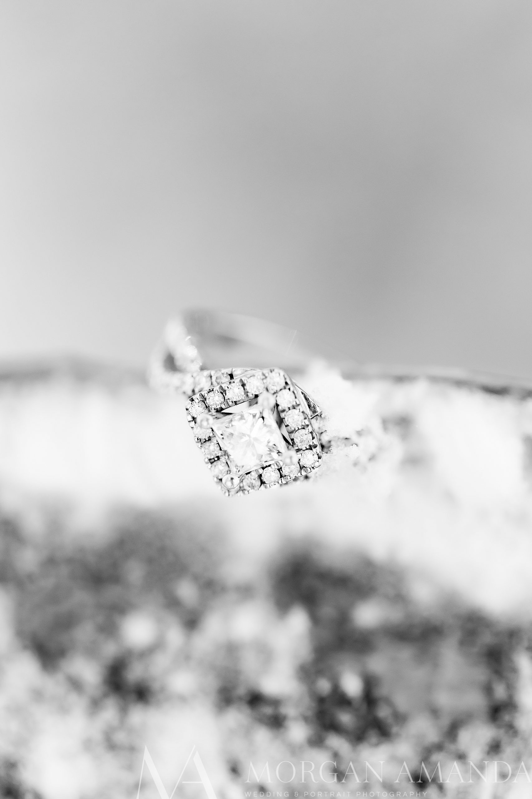 diamond ring rests on snow during winter Beech Mountain engagement session