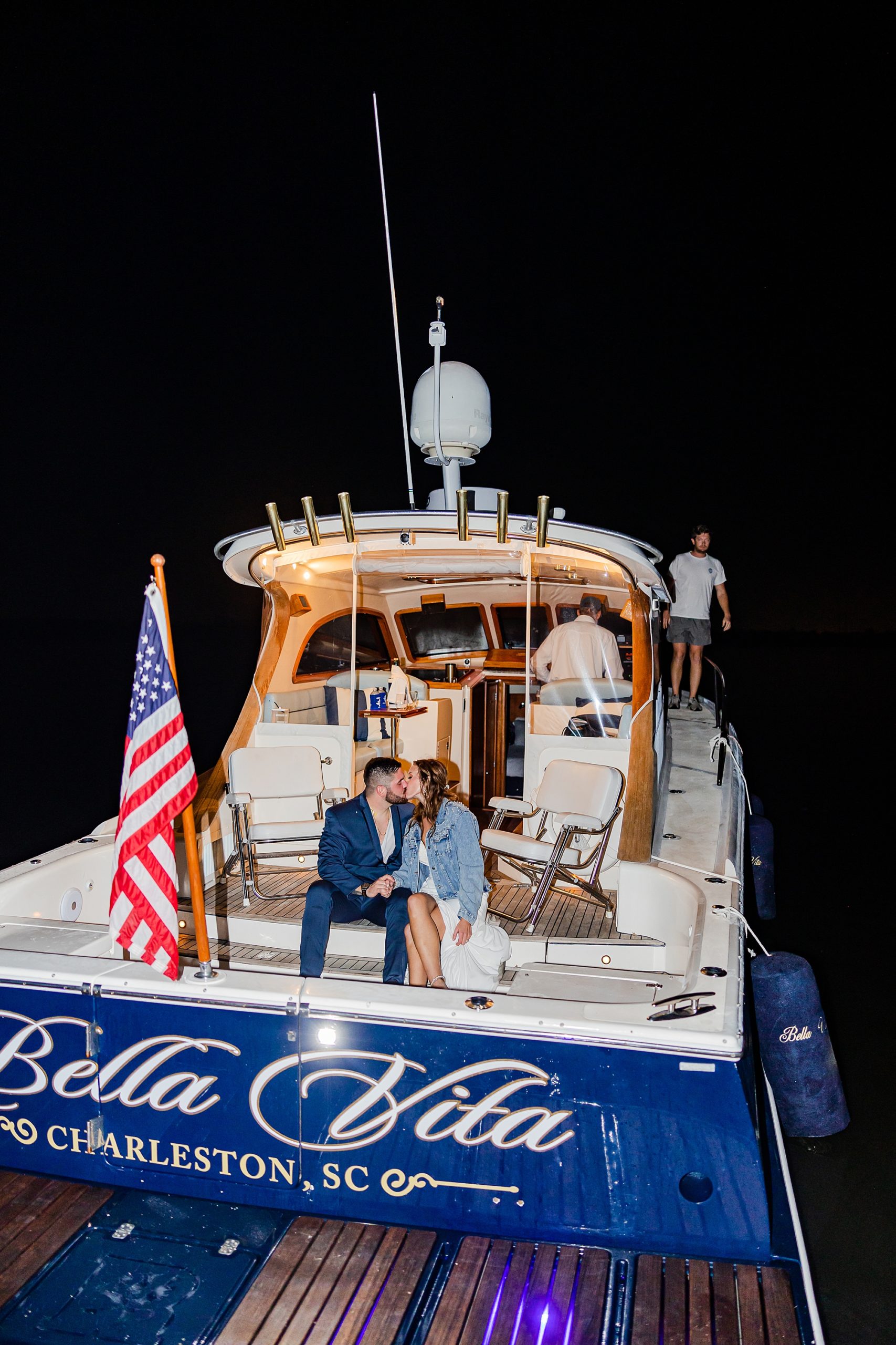 bride and groom kiss on boat during John's Island wedding night