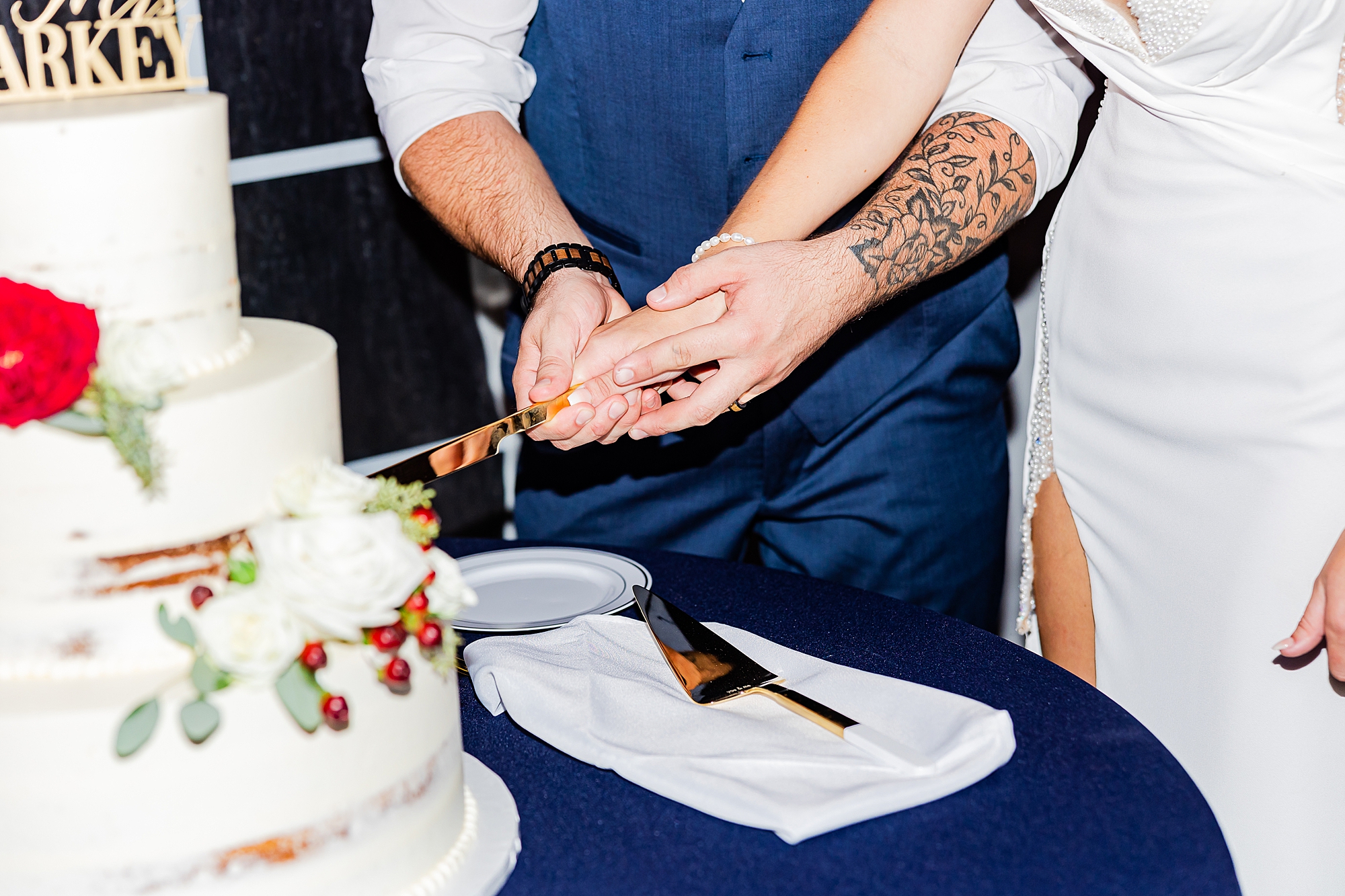 bride and groom cut wedding cake together 