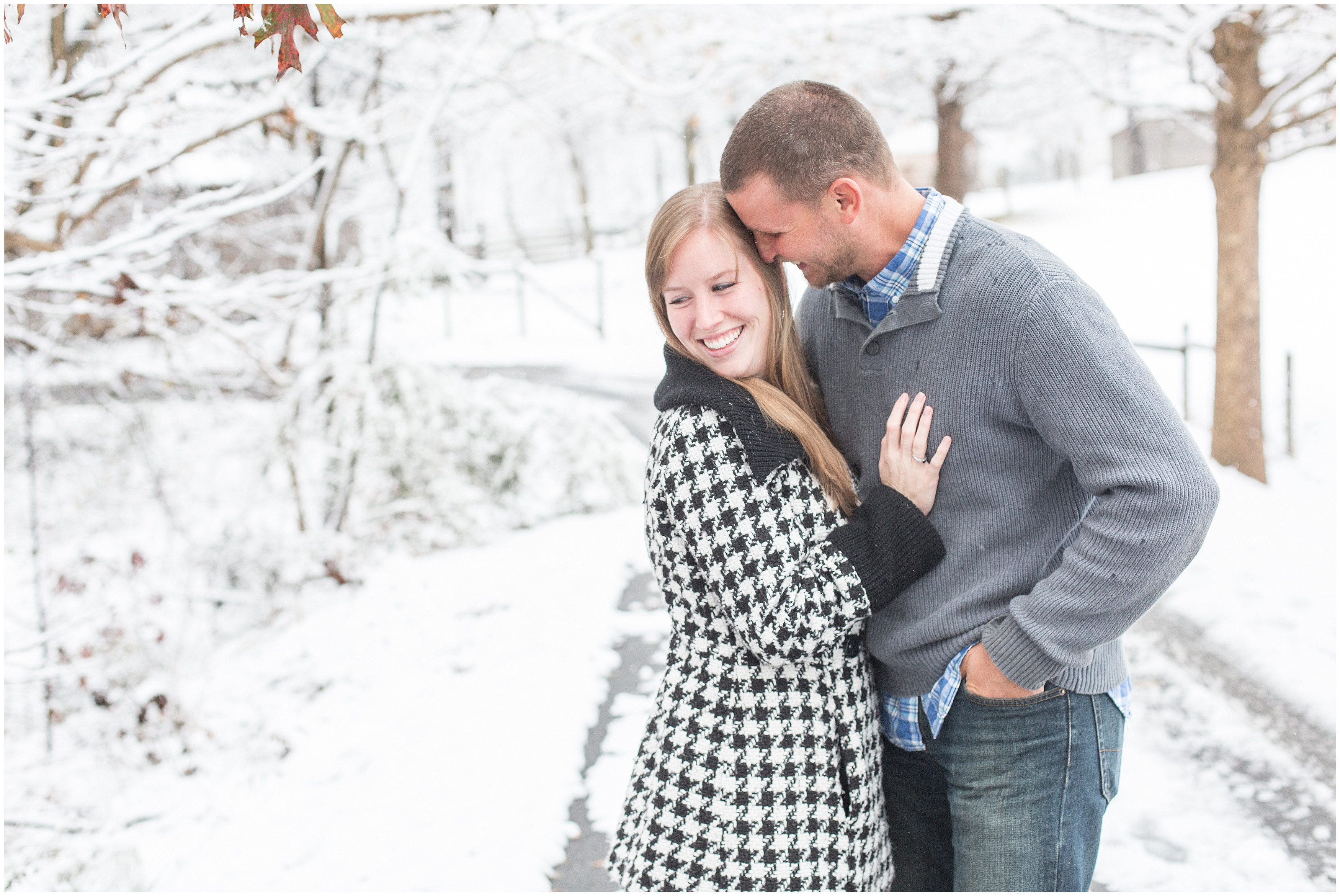 man leans into his soon to be wife during their snowy engagement session