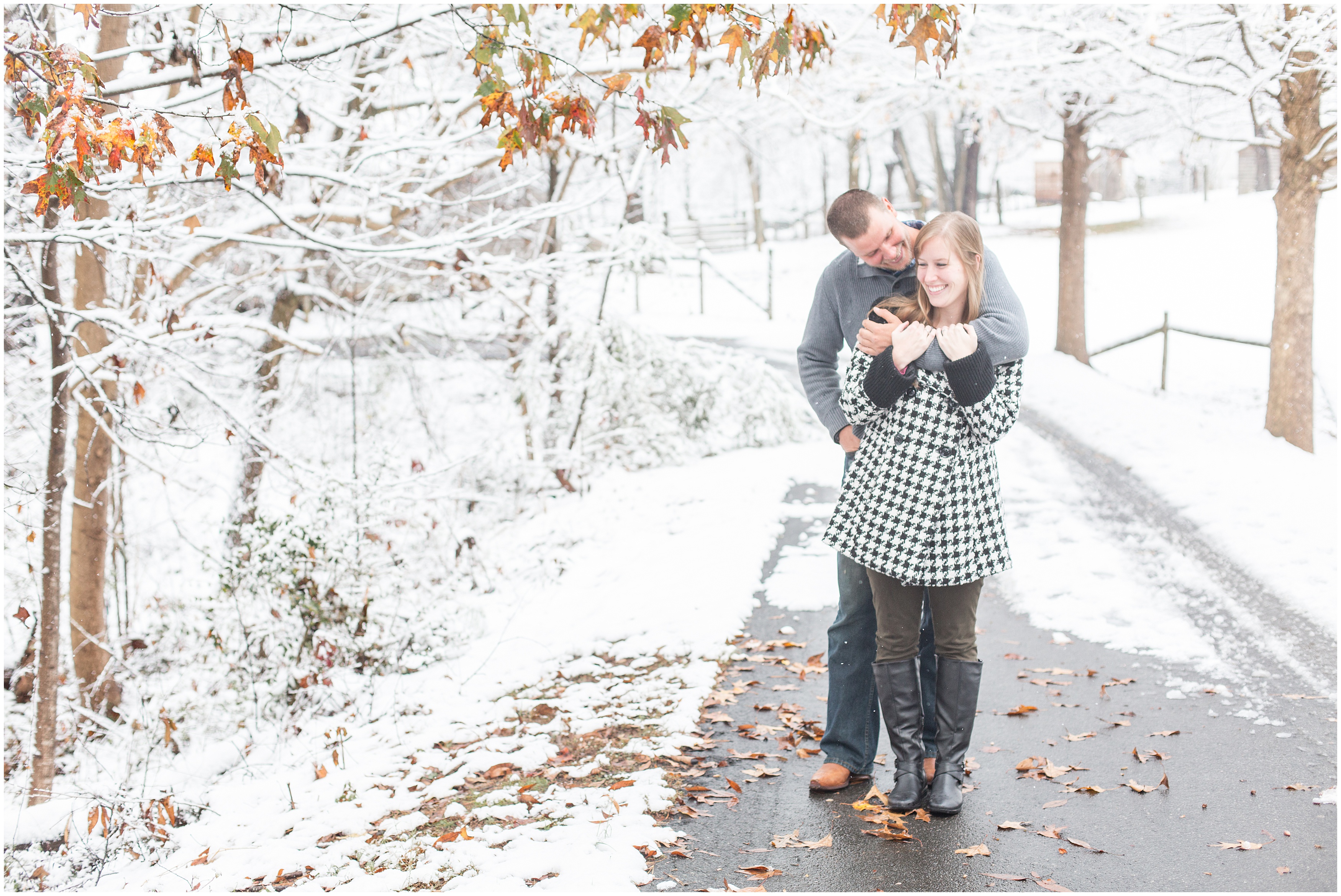 man leans down to hug fiancé during engagement session