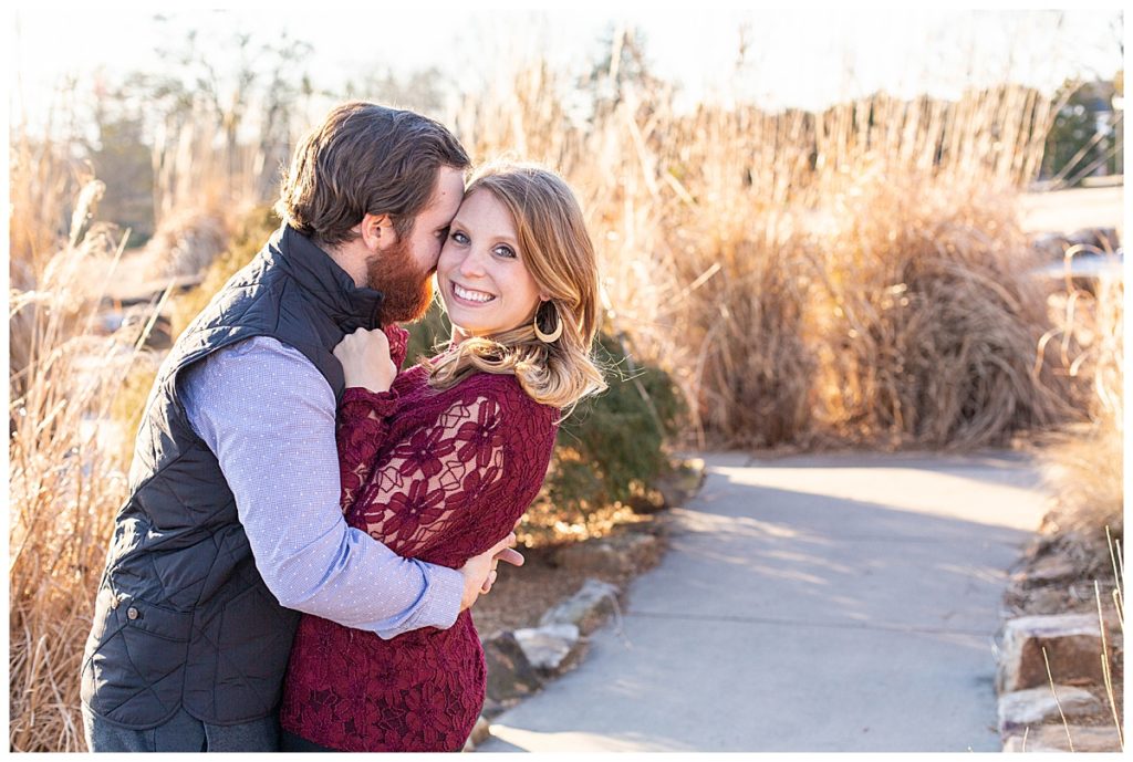 man hugs his fiance during engagement photos in Greenville SC Outdoor session