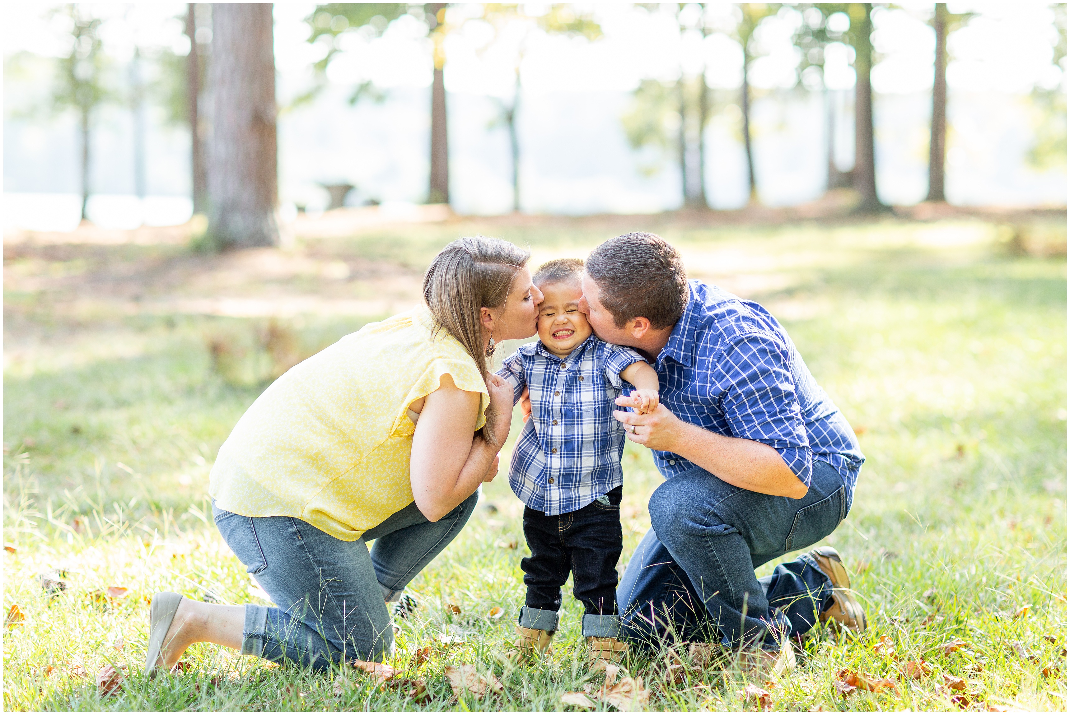 parents kiss son during Adoption Portraits