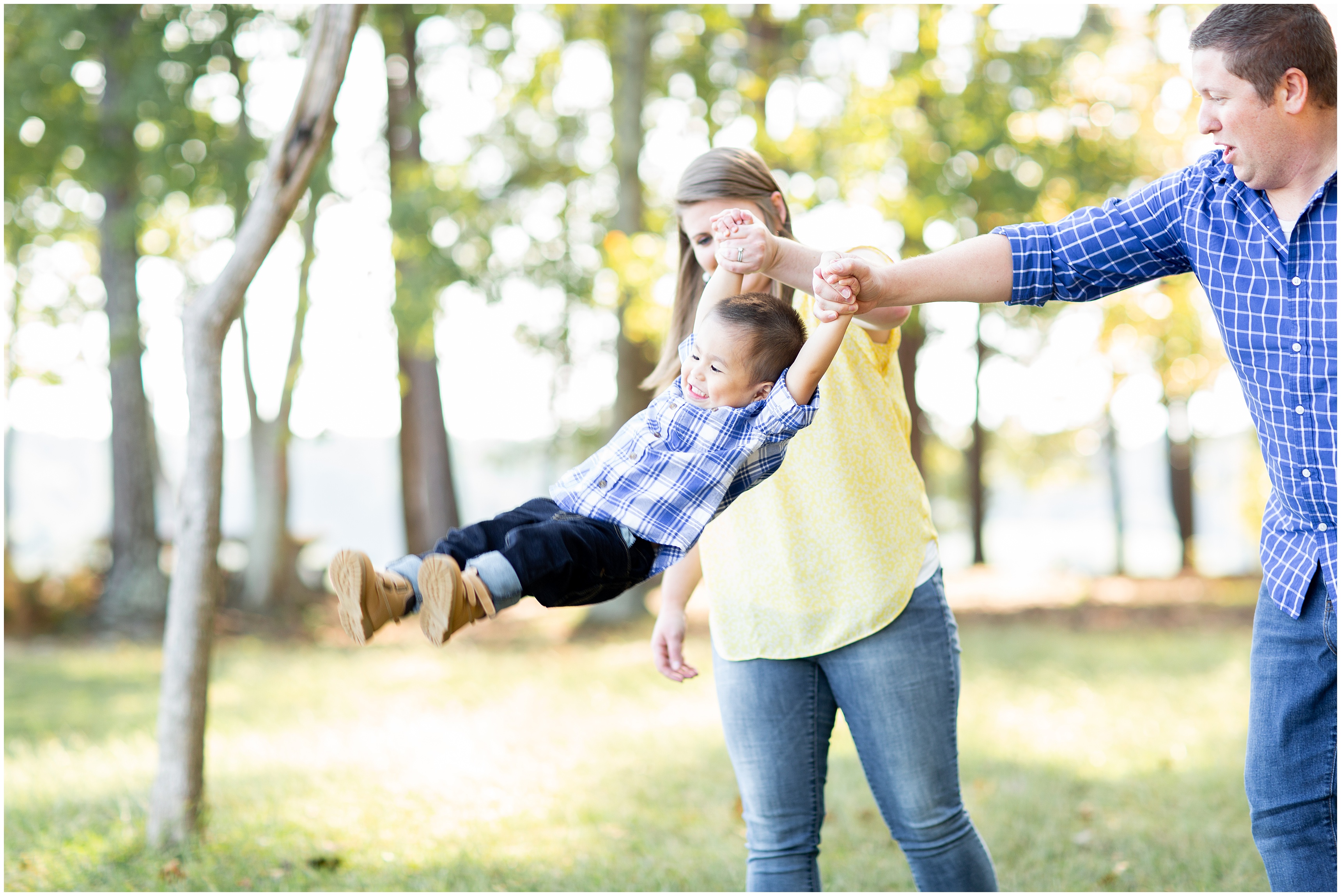 parents swing toddler during Adoption Portraits
