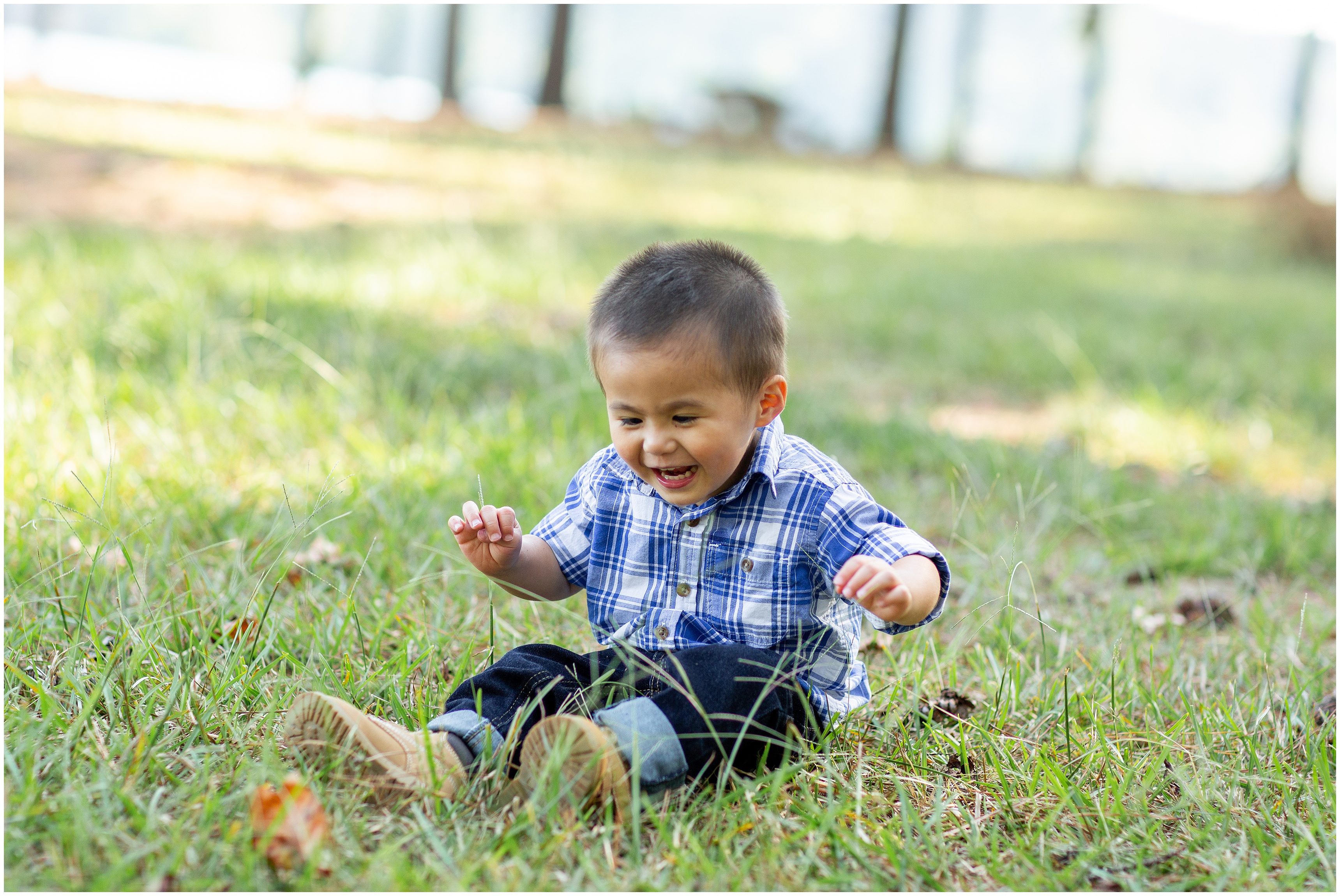 toddler plays in grass during fall family photos