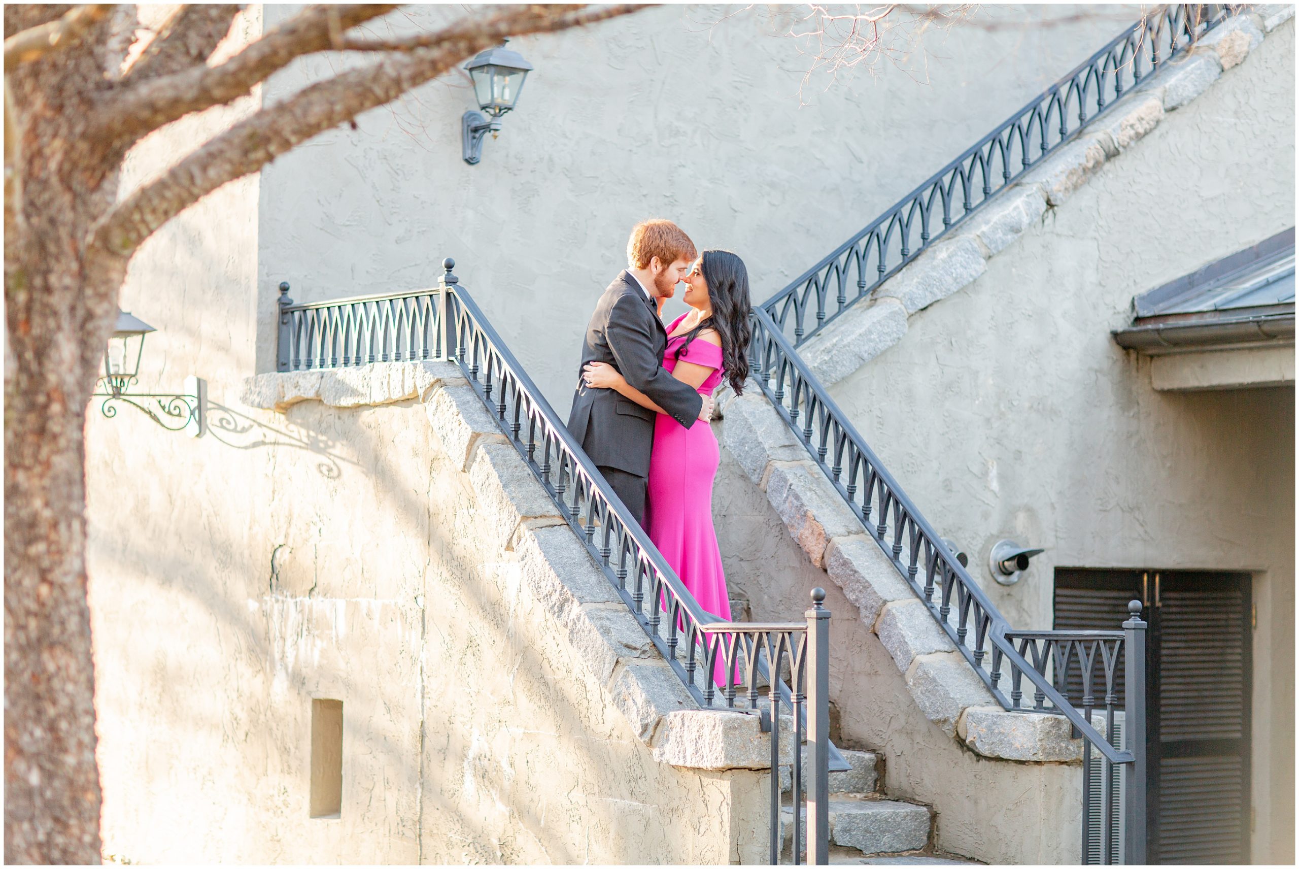 couple kiss on staircase at Hotel Domestique in SC for Engagement Session