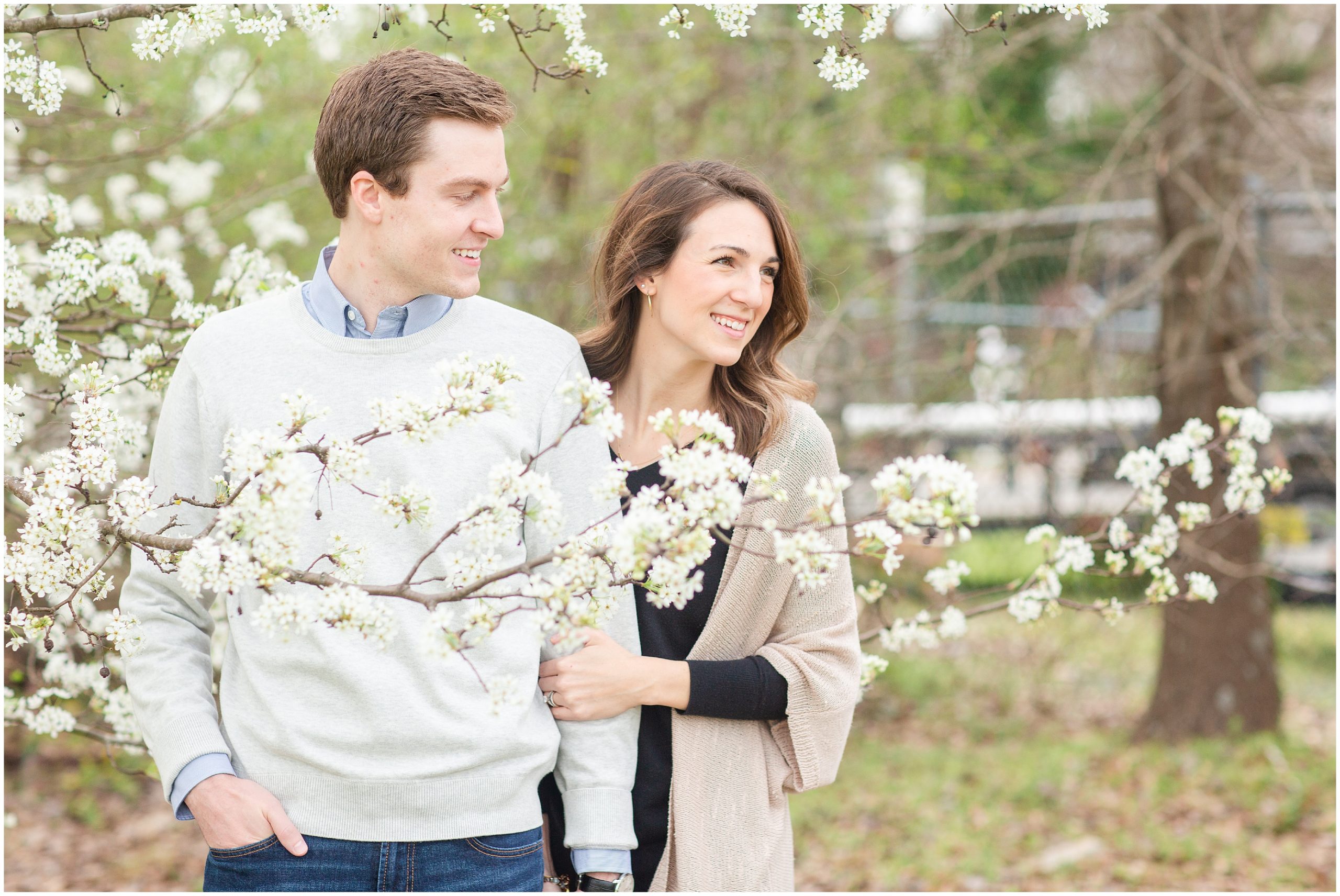 husband and wife pose by white tree