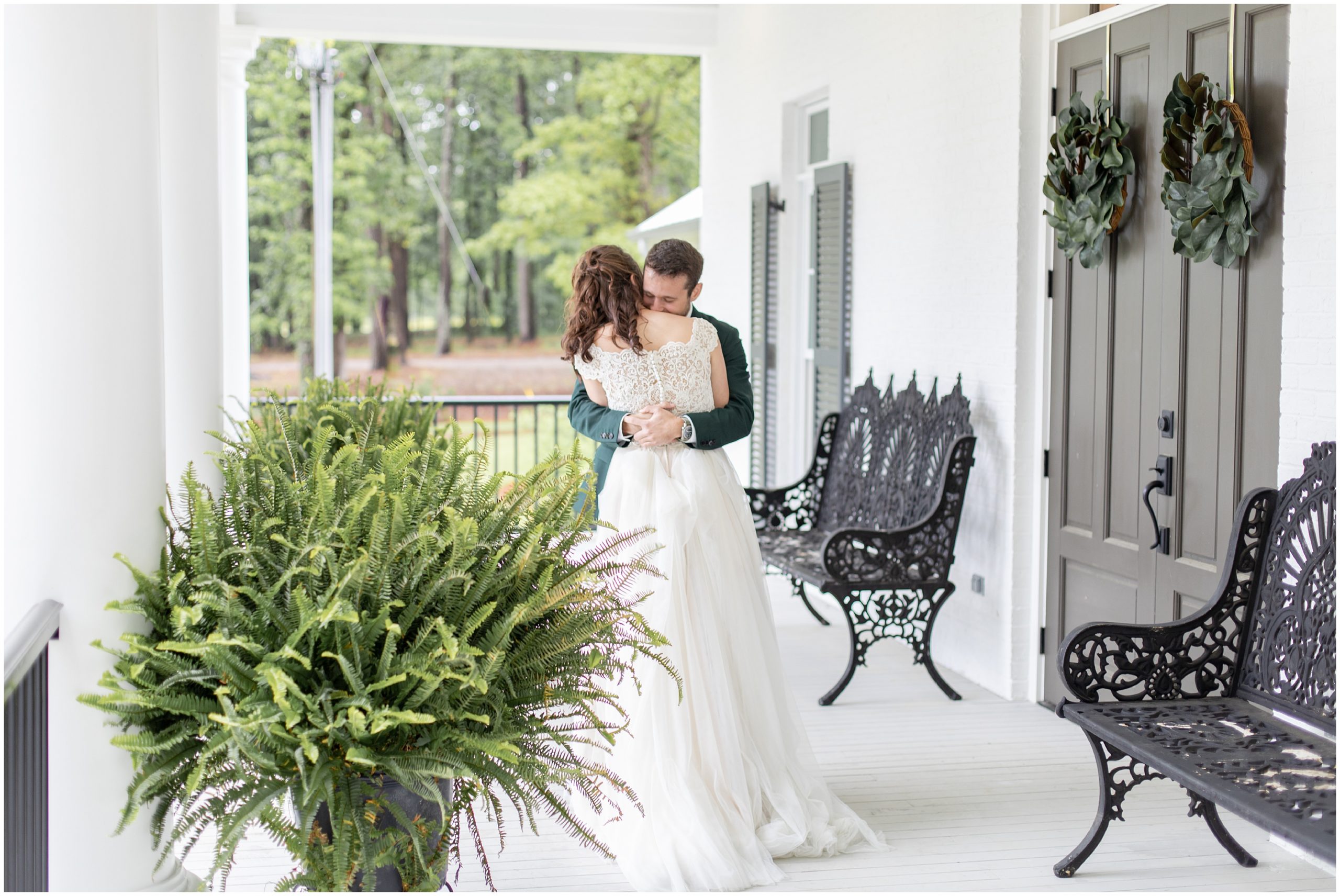 bride and groom hug on front porch during Southern Alabama Wedding at The Witt House